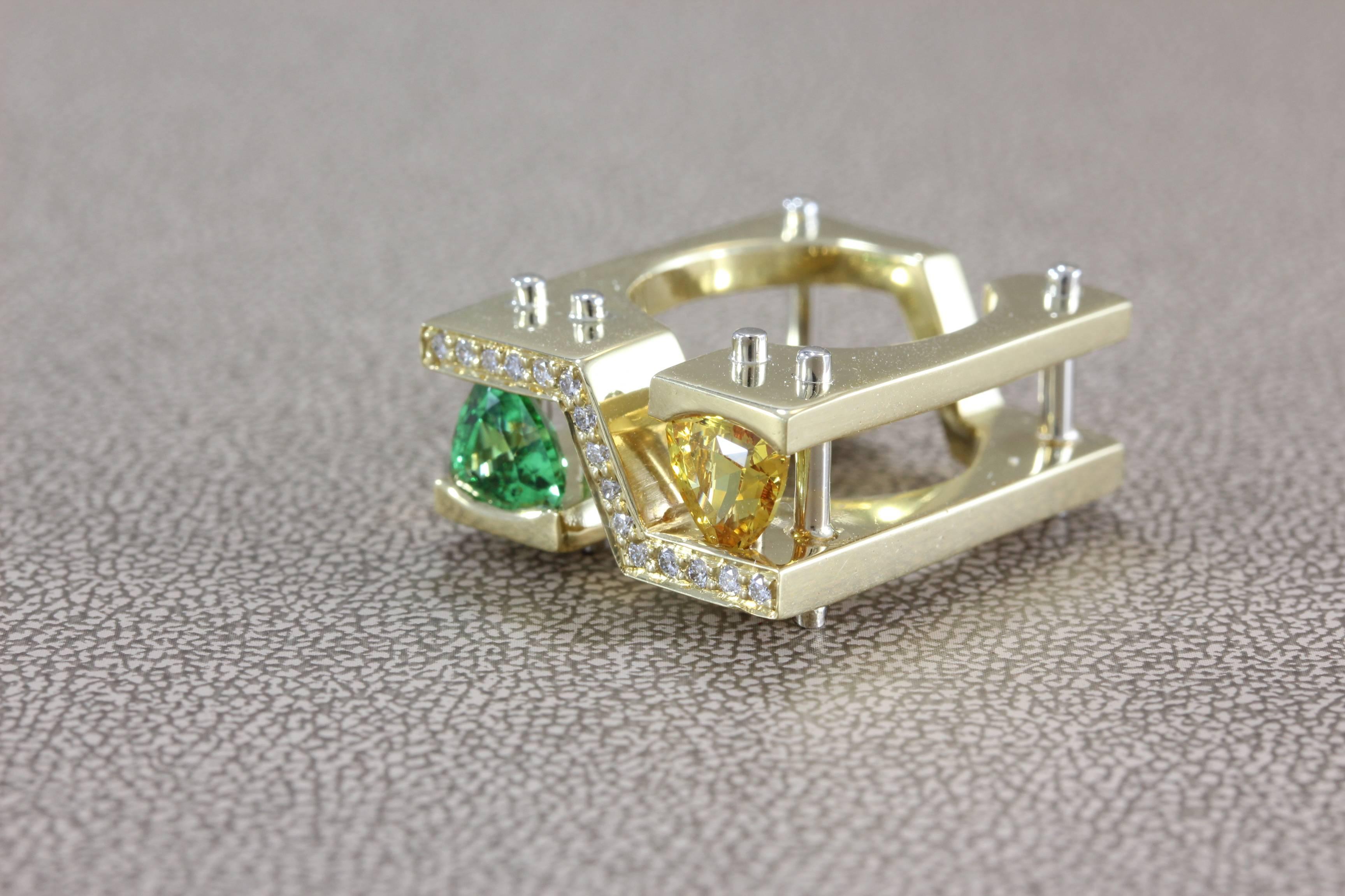 A unique modern ring with 1.00 carat Tsavorite and 1.00 carat Sapphires in a trillion cut. There are 0.12 carats of diamond pave to give the ring a bright accent, set in 18K yellow gold. 

Dimensions: 0.85 x 1.05 x 0.38 inches

Size 5