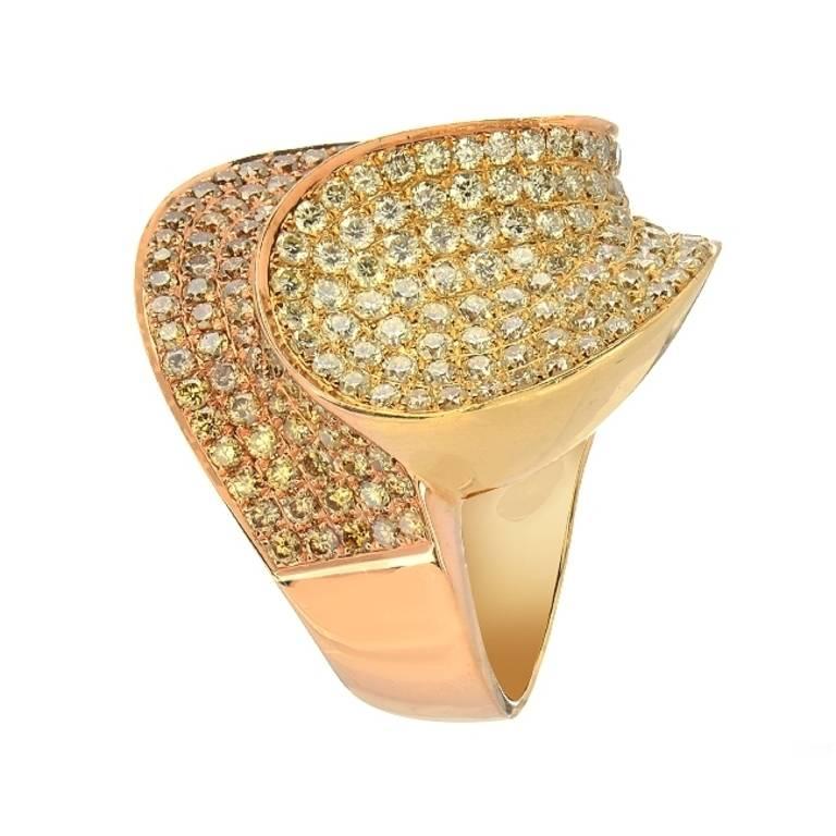 This yin and yang swirl cocktail ring set in 18K yellow and rose gold features 5.05 carats of fancy yellow colored diamonds. The round cut diamonds are pave set and cover the top of the ring and run along the shoulders as well.

Ring size 7
