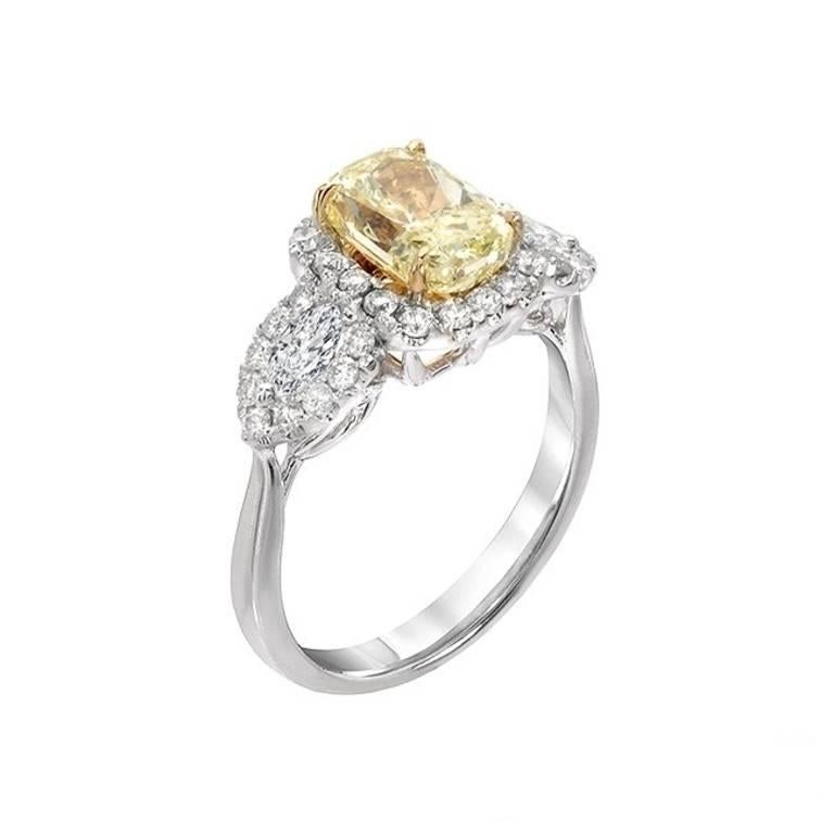The center fancy yellow diamond is a radiant cut with VS clarity, 2.08 carats. The white diamonds include two marquise shape diamonds and round cut diamonds which made halos around the yellow diamond as well as the marquise.The two marquise diamonds