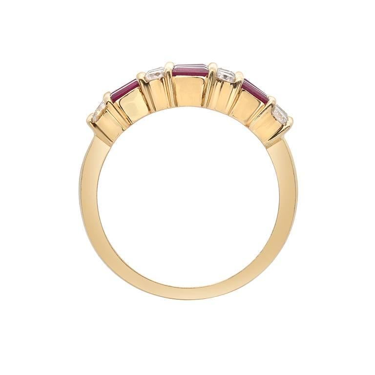 This tri-row Gemlok ring features 1.04 carats of baguette cut rubies alternating with 0.64 carats of white VS quality round cut diamonds. The gems are channel set in 18K yellow gold.

Currently ring size 6
