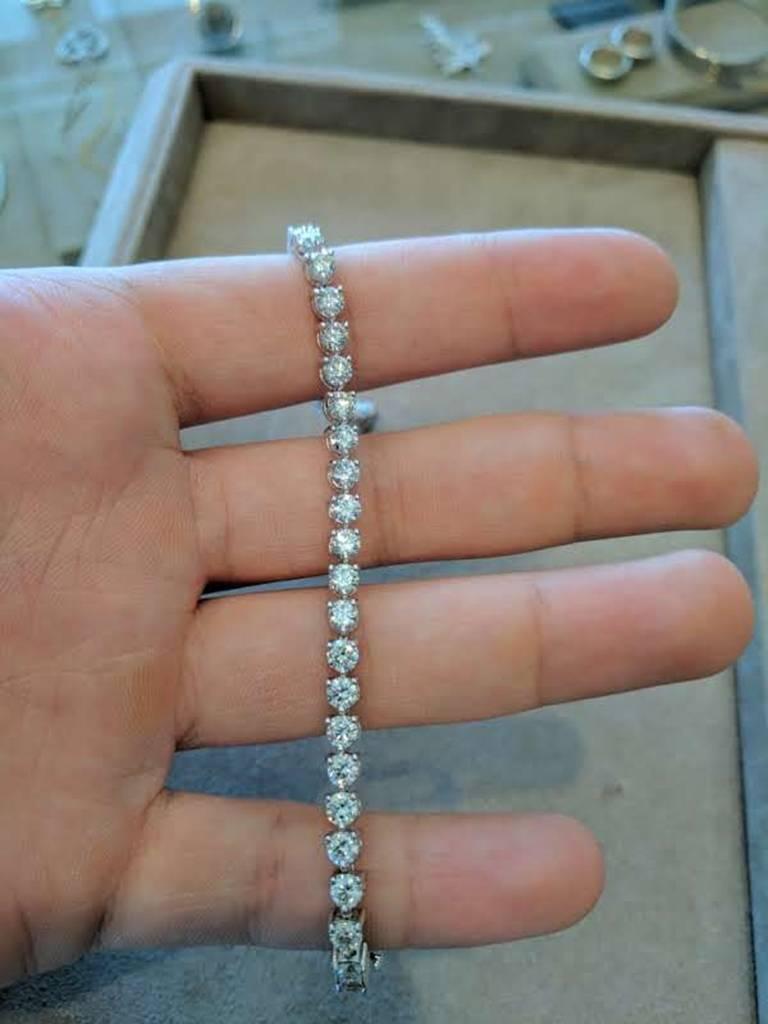 This tennis bracelet features 41 round cut diamonds, VS clarity and G-H color, weighing a total of 8.32 carats. The length of the bracelet is 7.5 inches. Made in 18K white gold. 