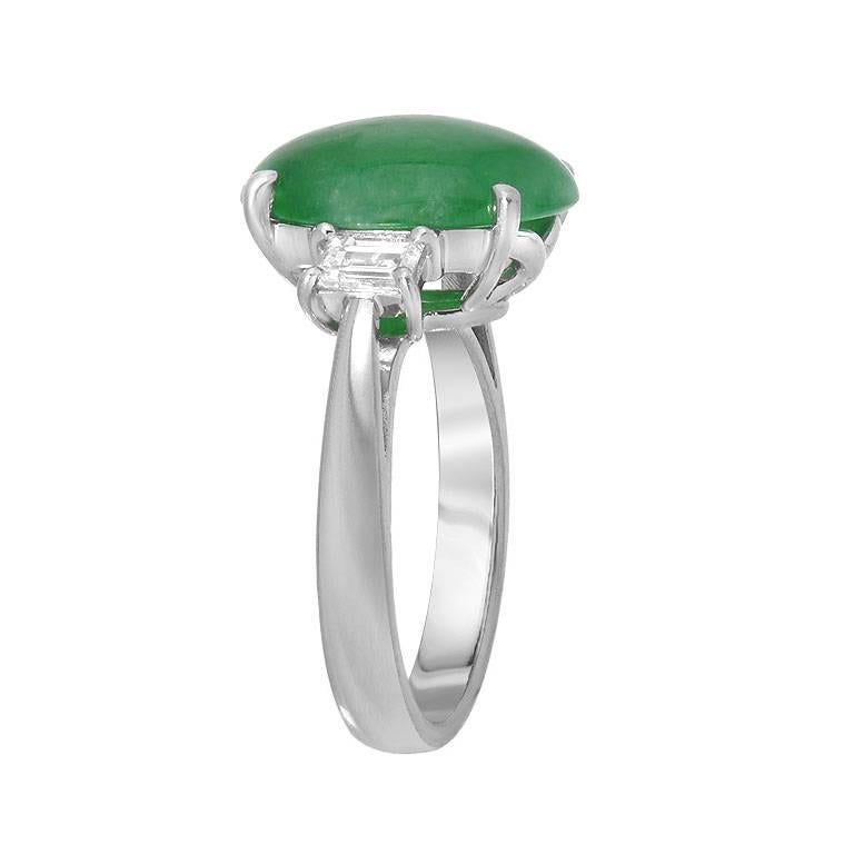 A semi-transparent 6.32 carat green jade ring. Along with the jade are two baguette cut diamonds, VS clarity E-F color, 0.56 carats, Set in platinum. 

Ring Size 6.25 (Sizable) 