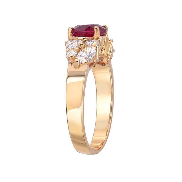 A 1.48 carat oval cut pigeon blood colored ruby. There are 8 diamonds, 4 marquise and 4 round cut diamonds weighing a total of 1.01 carats, VS clarity with G-H color, set in 18K gold. 

