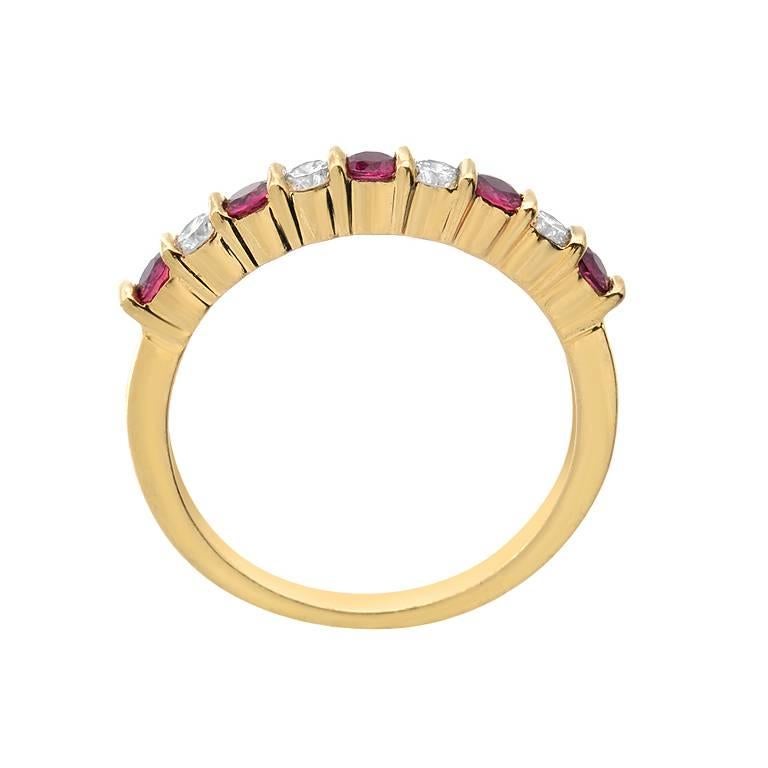 A band ring by designer Gemlok featuring 0.40 carats of precious round cut ruby and 0.25 carats of VS quality round cut diamonds. The alternating gems are set in 18K yellow gold.

Currently ring size 6