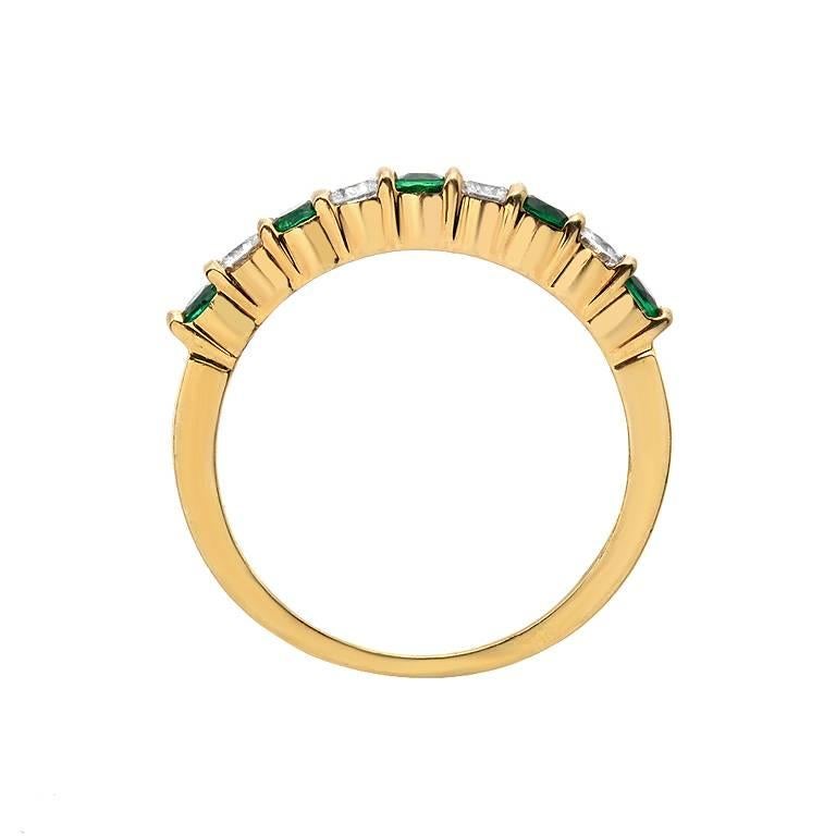 This Gemlok band features 5 round cut emeralds weighing 0.30 carats and 4 full-cut diamonds weighing 0.25 carats, set in 18K gold. 

