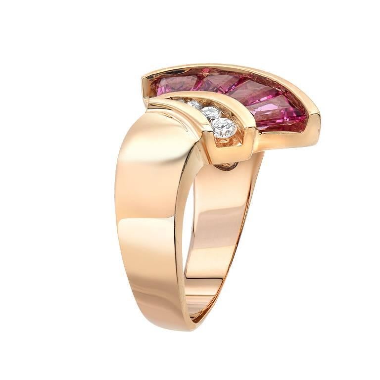 This fun and feminine ring features a vibrant inlaid opal set beside 1.90 carats of tapered baguette pink tourmalines and 0.14 carats of graduating round cut diamonds. This fan like designed ring is set in 18K yellow gold.

Currently ring size 6.25