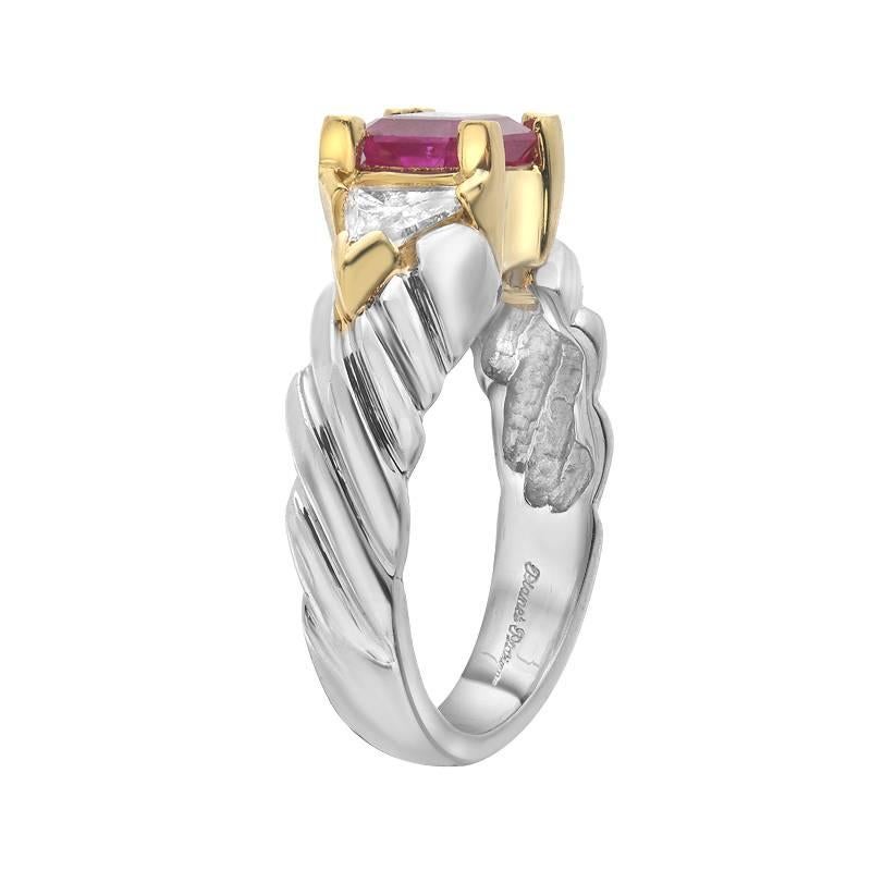 A platinum and gold ring featuring an intensely colored ruby weighing 1.50 carats. There are 2 trillion cut diamonds on the sides of the ruby weighing a total of 0.64 carats. A lovely ring with quality stones for a special woman.

Ring size 7