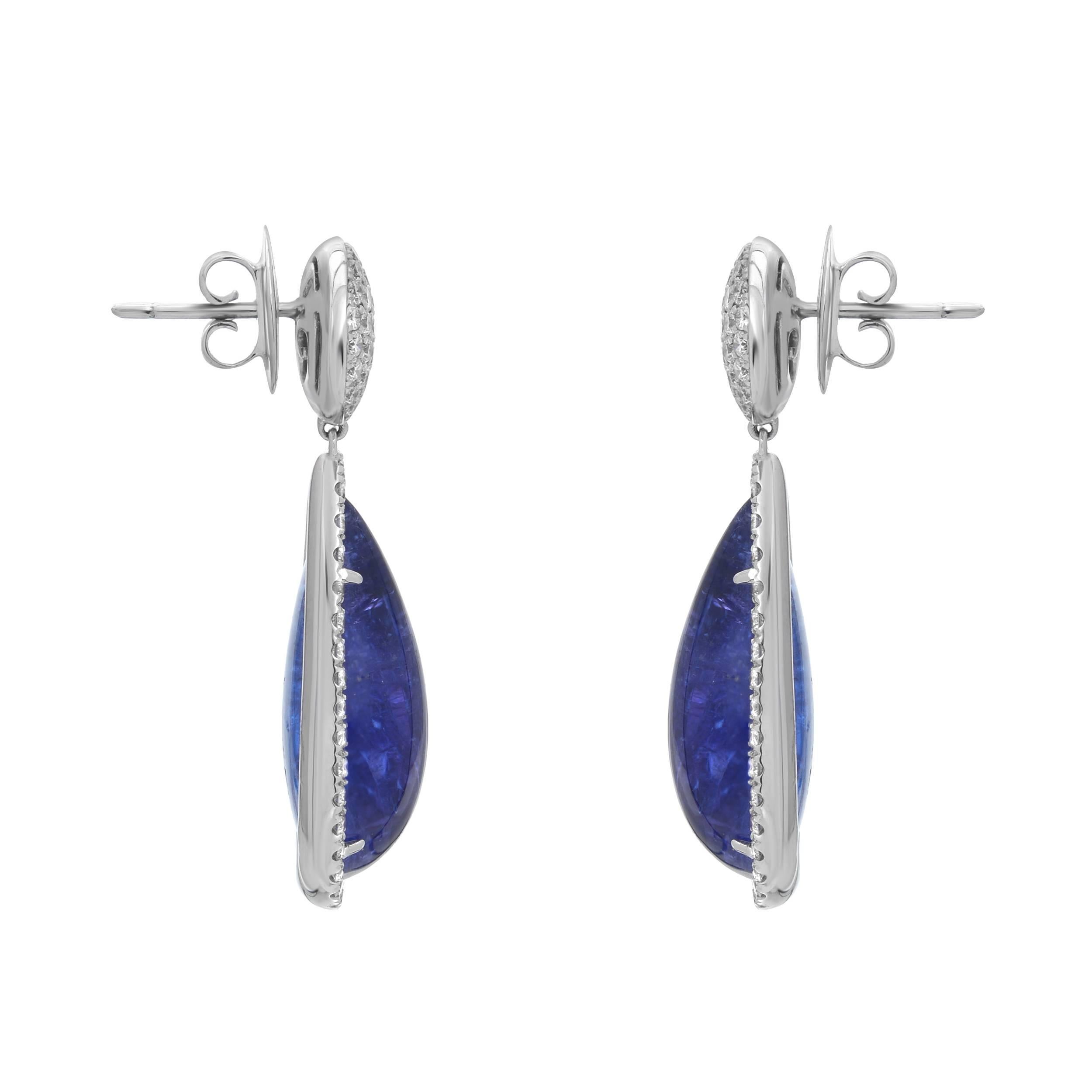 A pair of sophisticated drop earrings. The 47.42 carats of cabochon tanzanites are filled with life and gleam. There are 3.16 carats of white VS quality diamonds clustered at the top of the earring as well as haloing the cabochon tanzanite. Set in