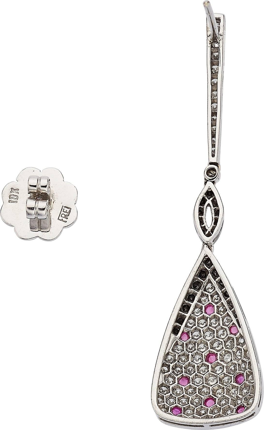 A fun pair of drop earrings by designer Eli Frei. There are 0.40 carats of black diamonds with 1.60 carats of white diamonds and 0.33 carats of round cut cabochon rubies. Set in 18K white gold.

Earring Length: 2.10 inches
Earring Width: 0.50 inches