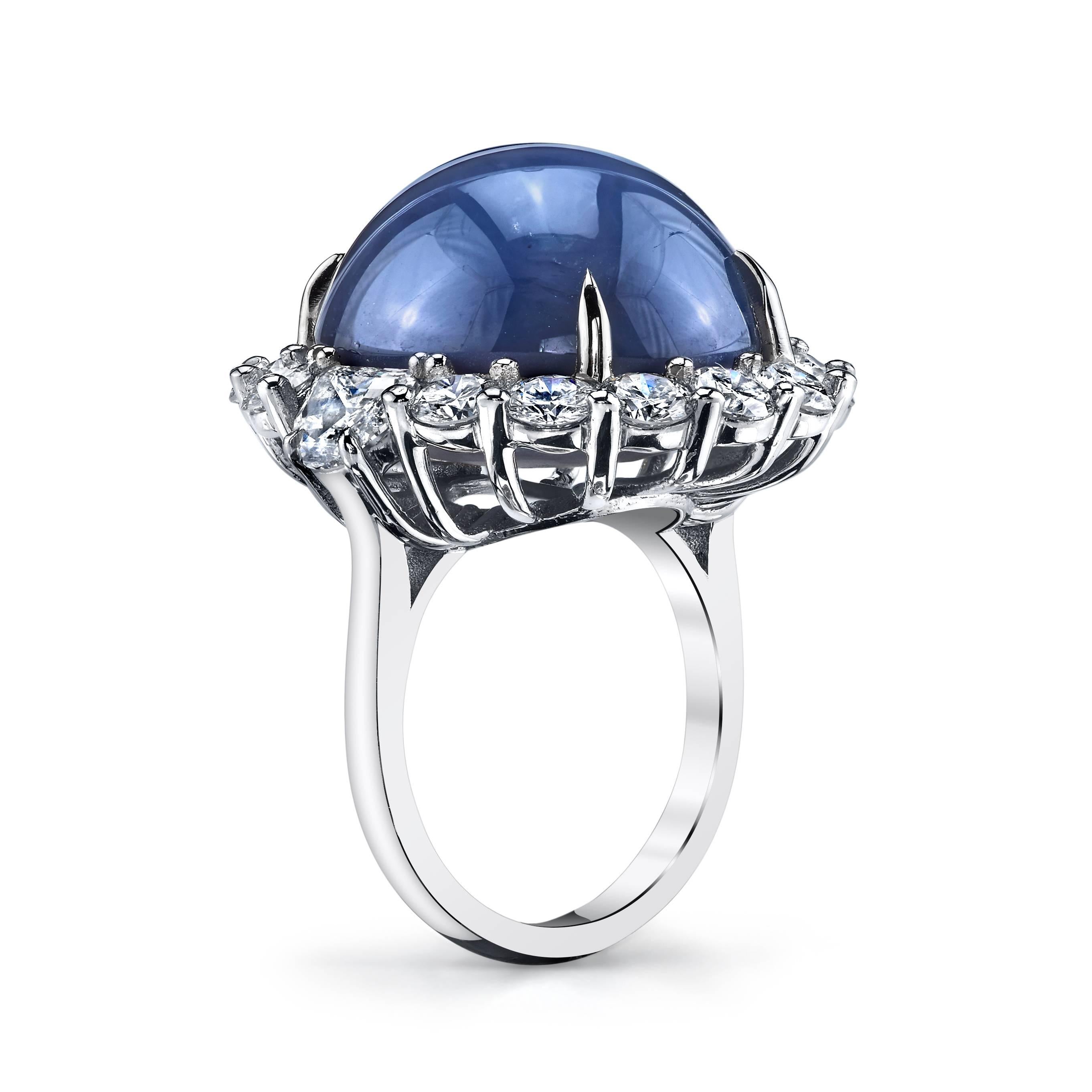 This phenomenal ring features an impressive gem quality 47.37 carat star sapphire with strong asterism (6 ray star effect). A halo of 4 carats of colorless VS quality diamond surround the impressive sapphire, set in platinum. 