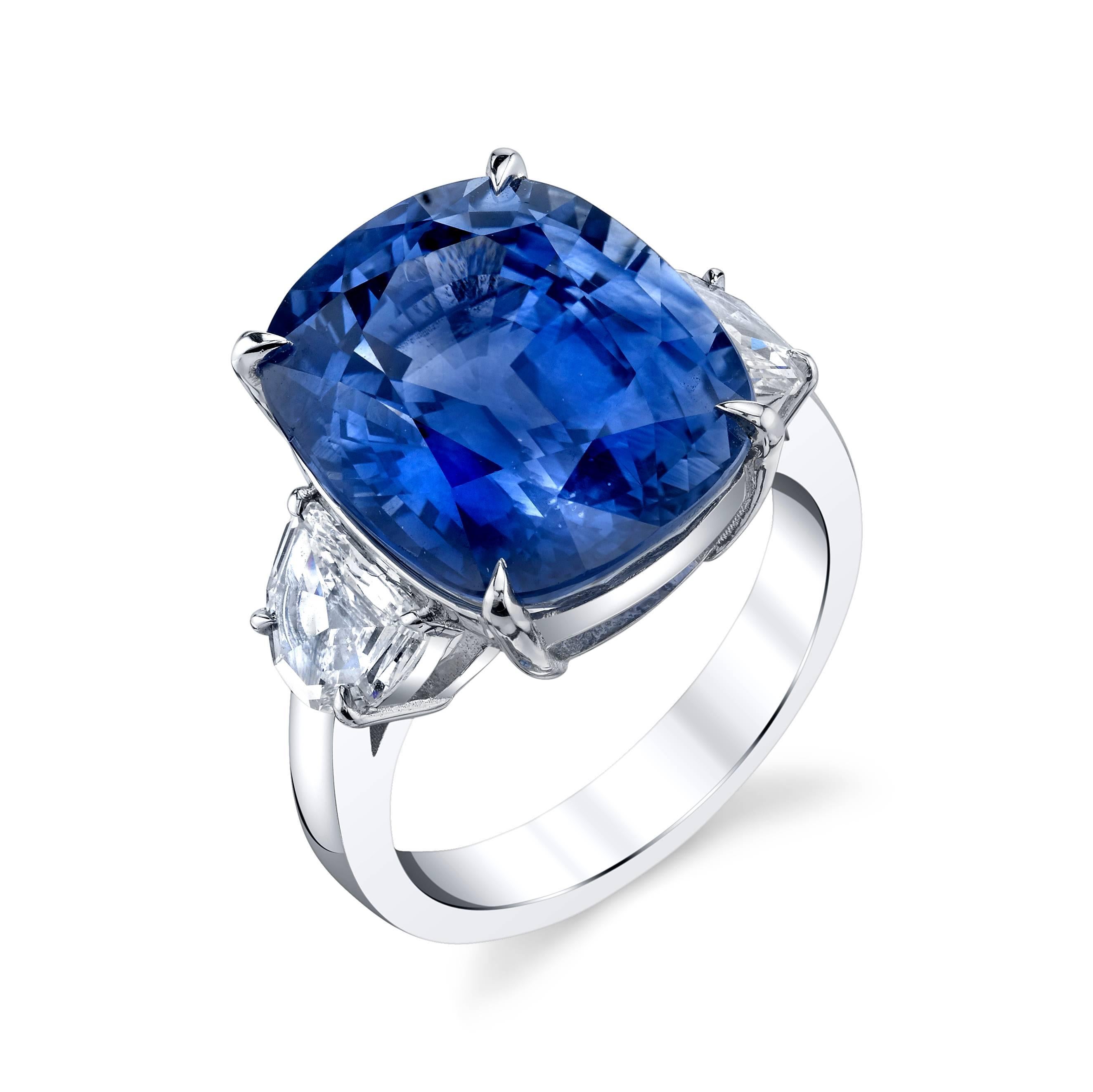 This amazing ring features a GIA Certified 15.39 carat sapphire in an ideal cushion cut.  It is a beautiful cornflower blue color with no visible inclusions. It has two shield cut diamonds, 1 carat total weight, complementing the center sapphire.