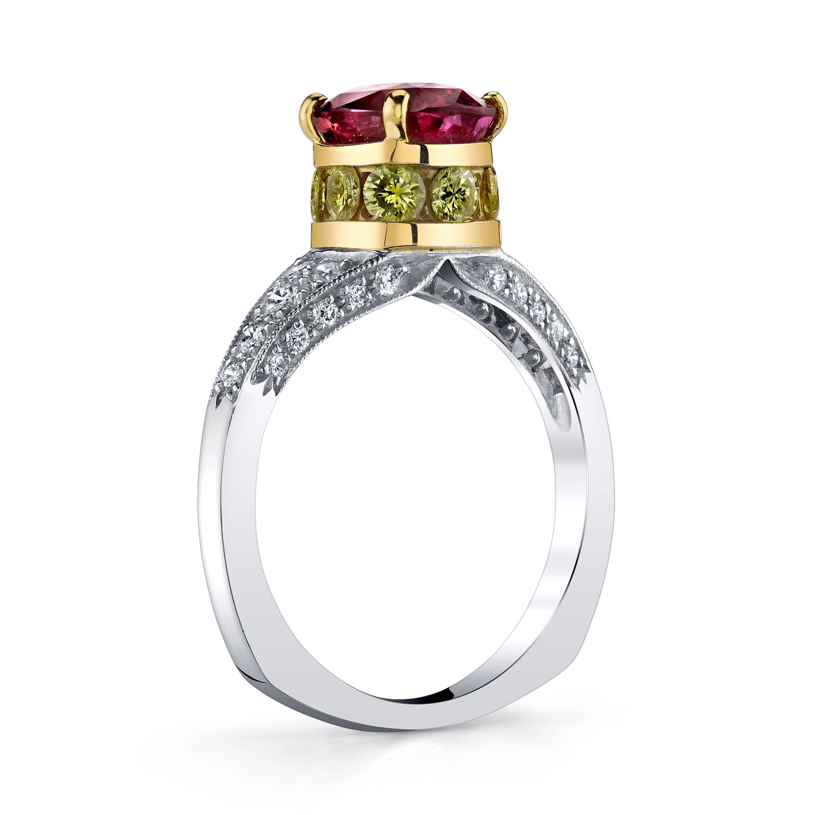 This magnificent ring features a GIA certified 2.60 carat natural ruby in a cushion cut.  GIA states it is from East Africa and has a purplish red color. This impressive ruby is complemented by 0.64 carats of round cut yellow diamonds set in 18K