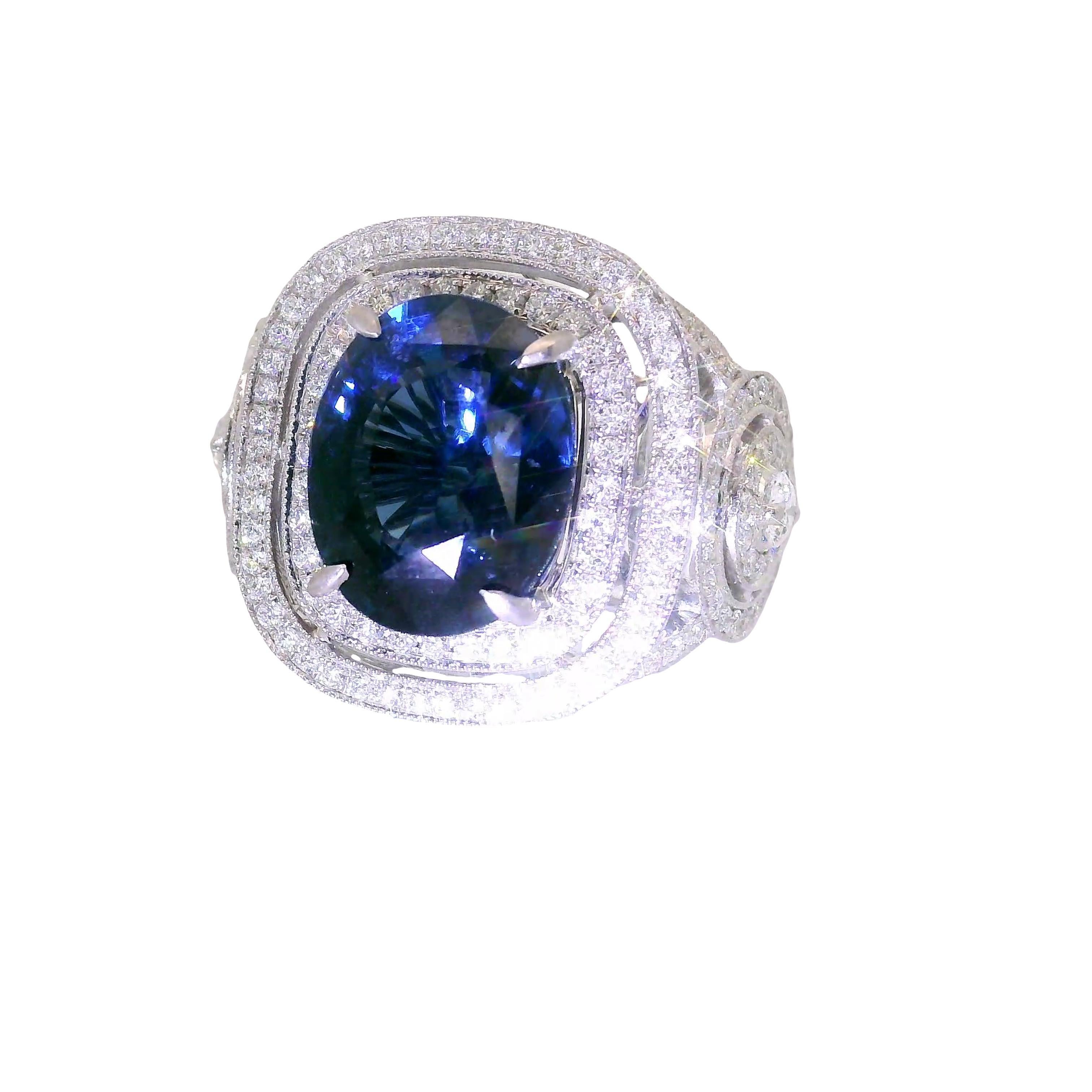 A captivating ring featuring a central blue spinel, cut in an elegant oval shape, weighing 5.79 carats. The deep blue hue of the spinel is accentuated by 1.34 carats of diamonds set around the spinel in an antique inspired design. These diamonds