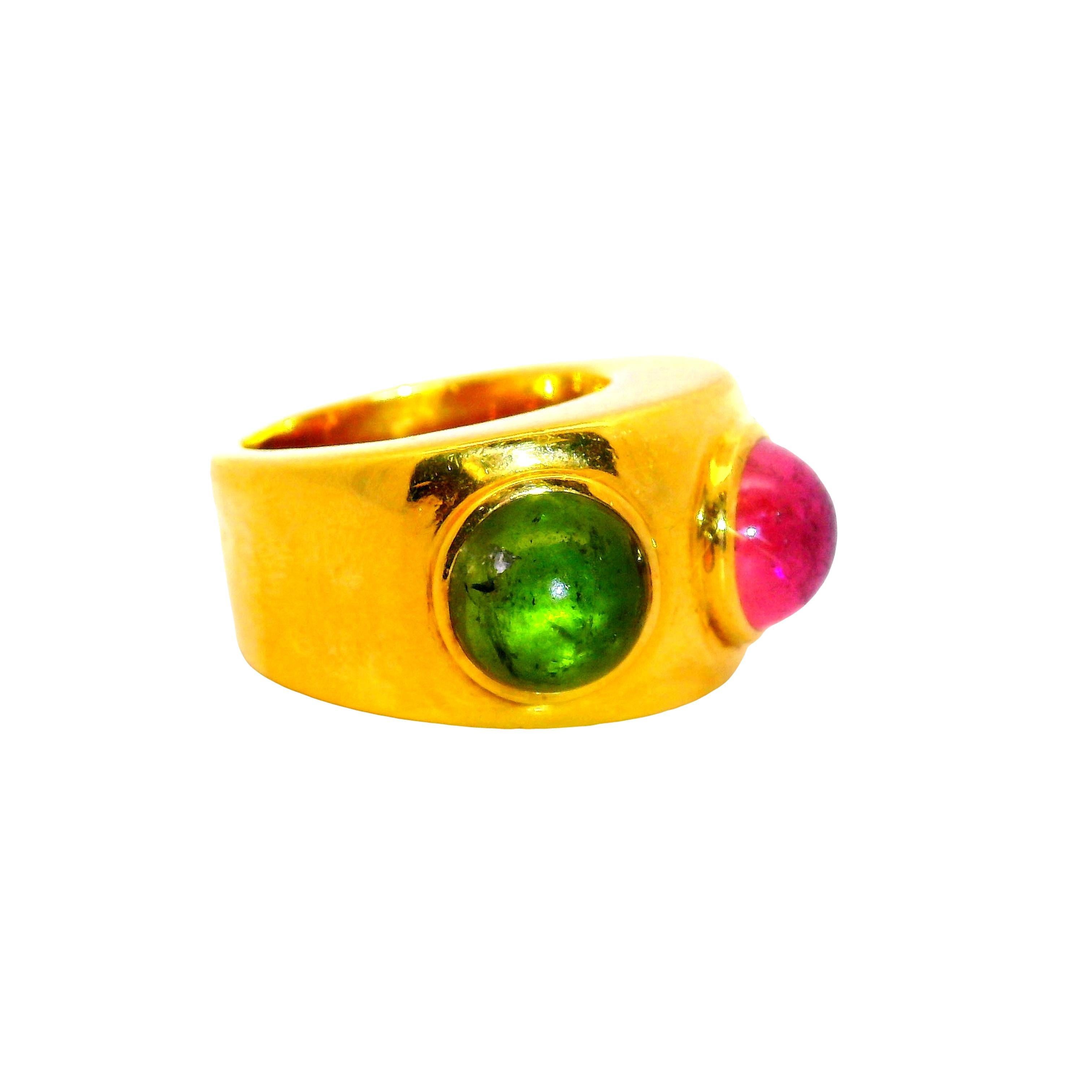 A bold fashion ring by Parisian designer Dominique Aurentis featuring a pink and green tourmaline weight a total of 4.00 carats along with a blue sapphires weight 2.50 carats. Crafted in 22k yellow gold, this piece showcases the timeless class of