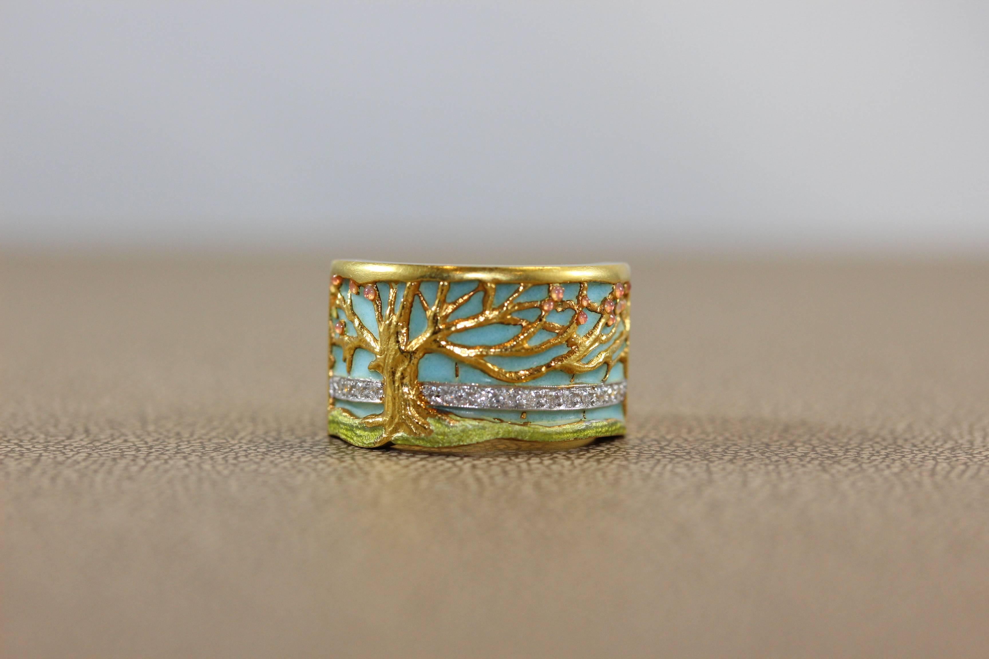 A creative and beautifully made ring by Masriera showing the tree of life with gem apples, diamonds and plique-a-jour enameling. Crafted in 18K yellow gold, the band can be sized.

