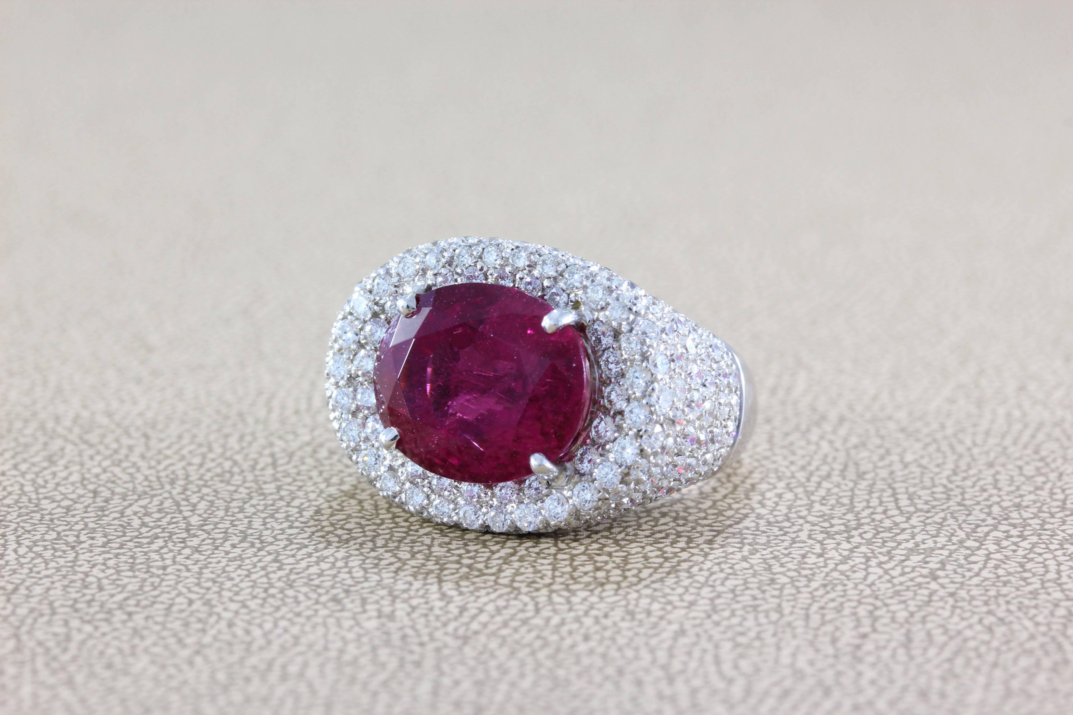 A ring featuring a superb gem rubellite tourmaline weighing in at 12.16 carats. This gem displays a magnificent vivid raspberry red color that rivals the finest of rubies. Accenting the gemstone are over 4 carats of full-cut diamonds, all set in 18K