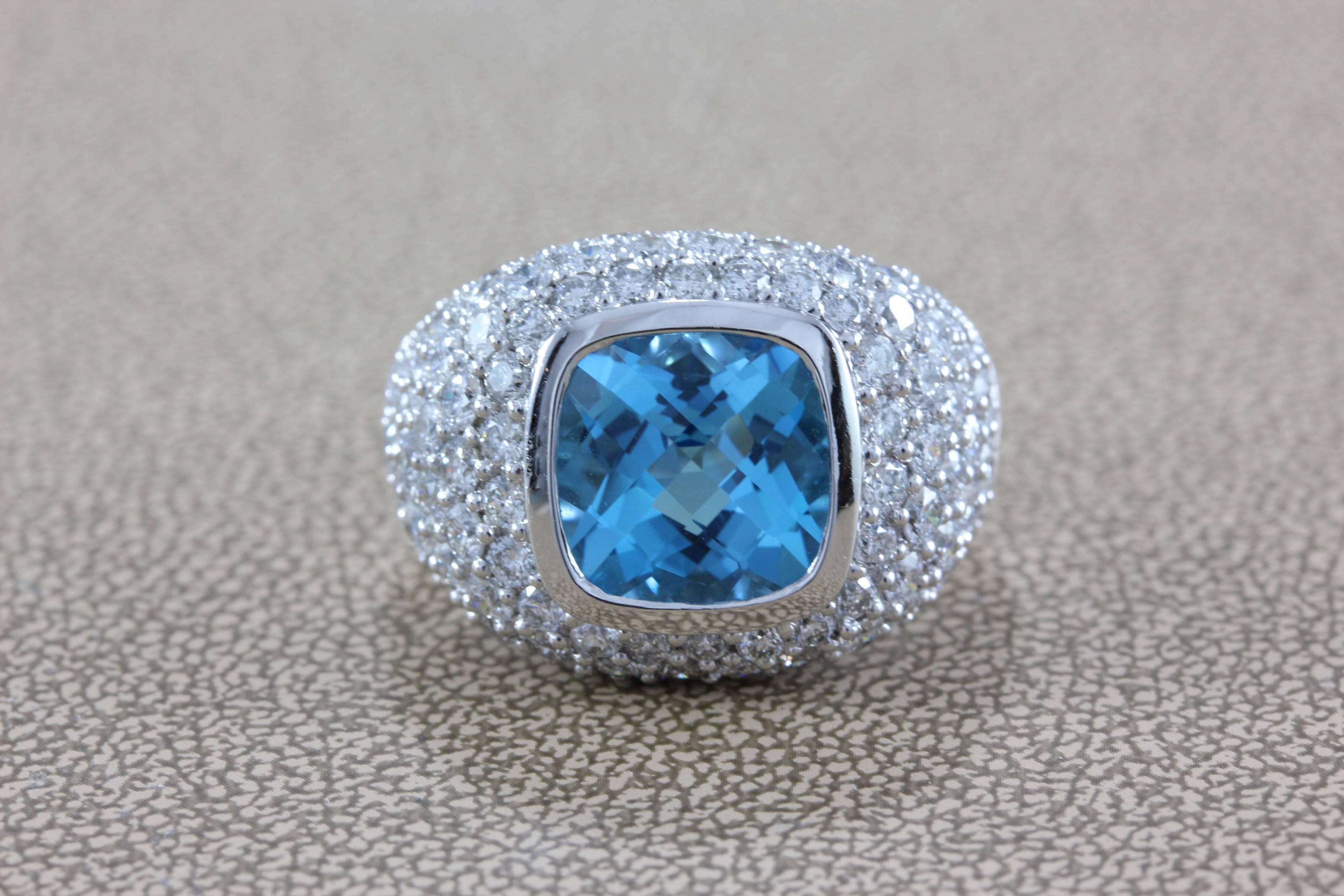A beautifully designed ring featuring a 4.22 carat cushion cut blue topaz, which is surrounded by almost 3 carats of VS quality round cut diamonds, set in 18K white gold. 

Size 7
