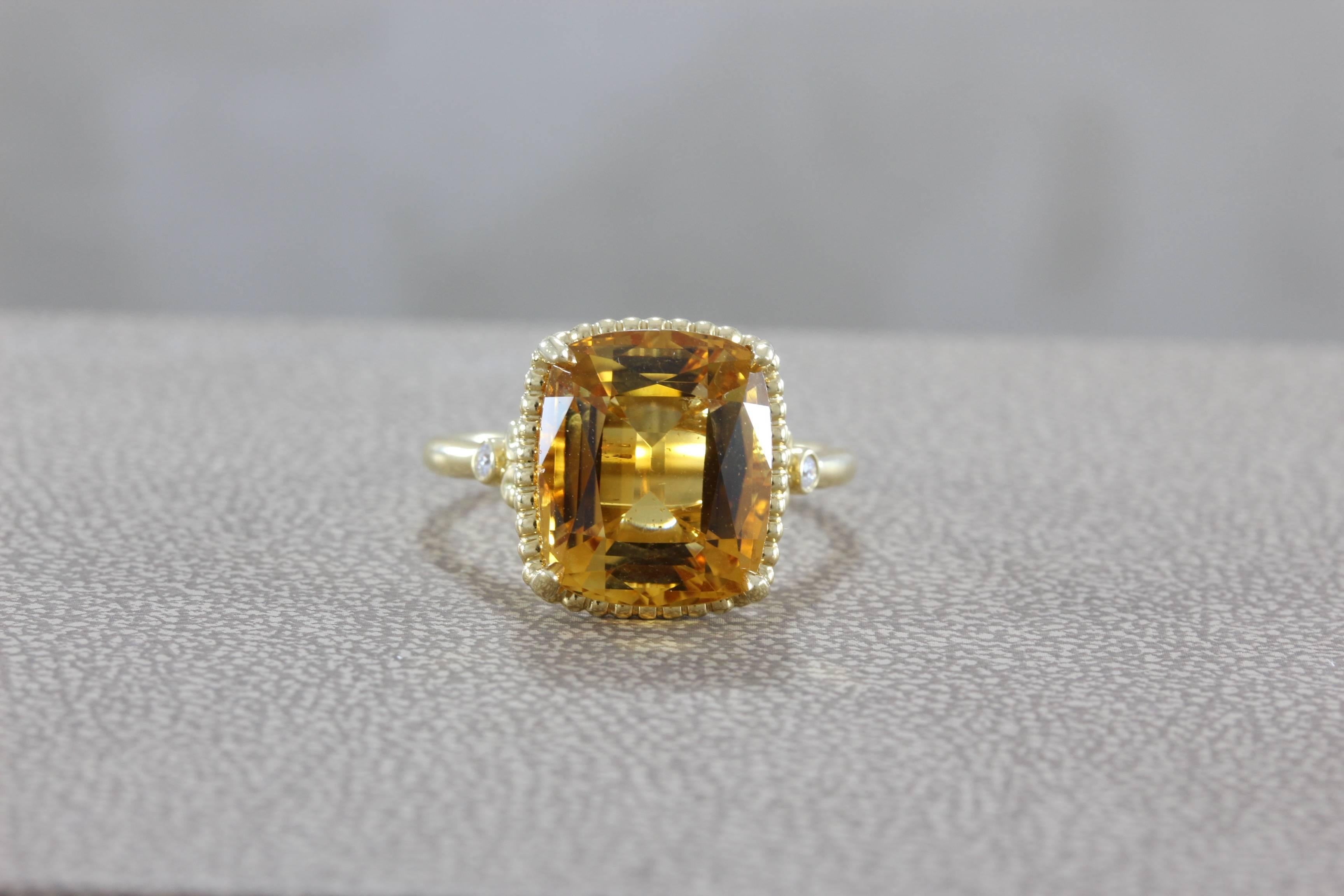 This Tiffany and Co. ring features a gem quality (approximately) 12 carat cushion cut citrine.  Set in 18K yellow gold with two diamond accents.  A great ring to wear everyday or dress up for the evening.  

Ring size 8 ½

