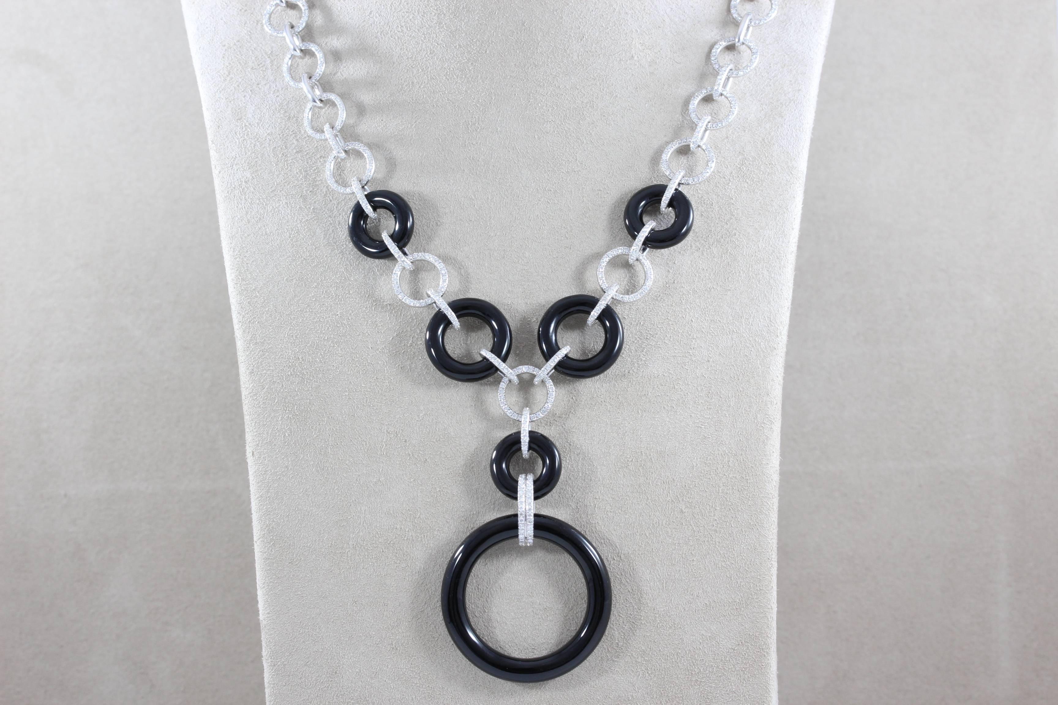 A unique necklace featuring over 3 carats of VS quality round cut diamonds set in 18K white gold. Fine jet black onyx carved into perfect circles are linked together with the gold diamond studded links. A clean sophisticated look.  

Length: 11