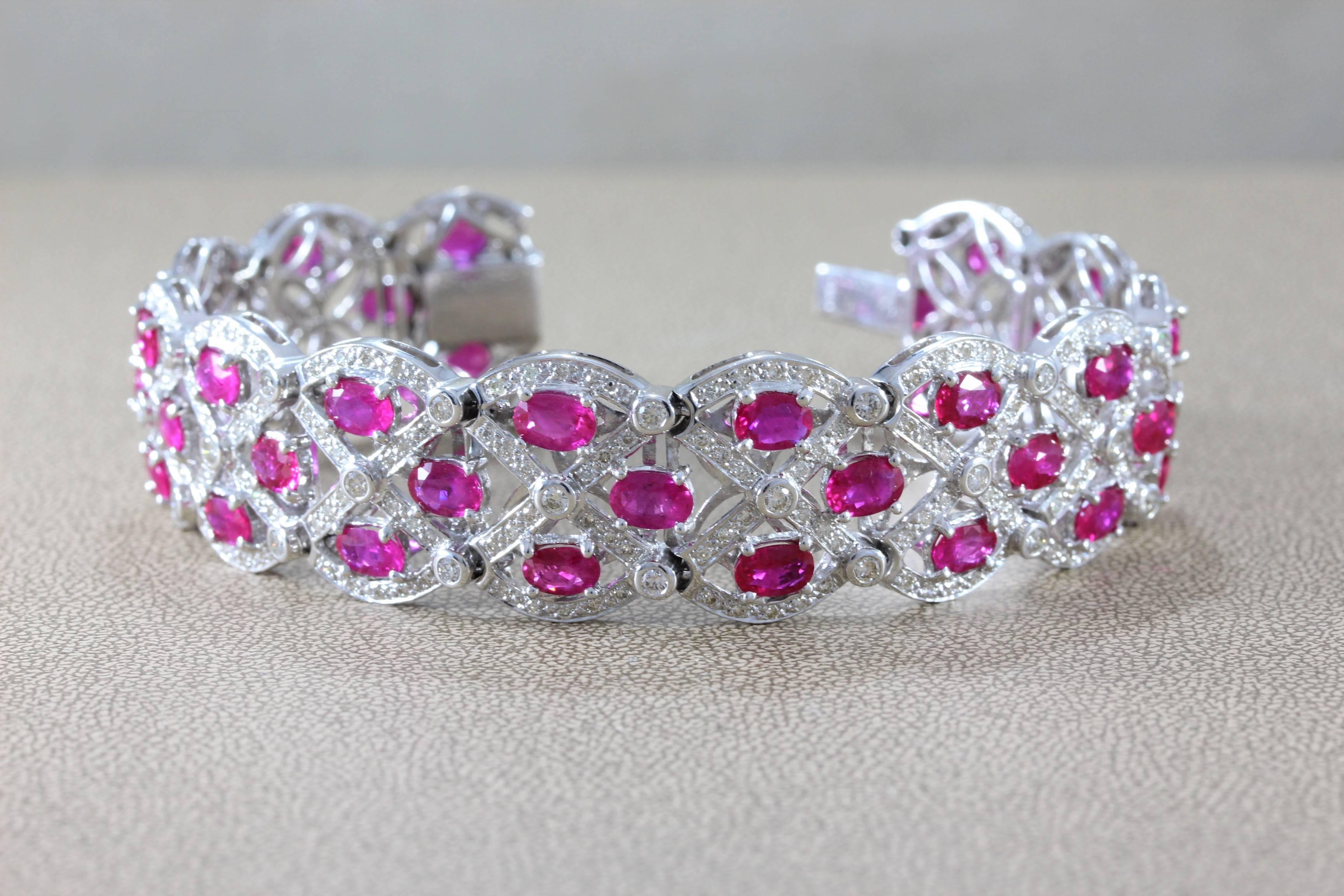 Fiery bursts of red flashes can be seen emanating from this bracelet which features over 20 carats of vivid red oval shaped rubies. Raining down sparkles and brilliance are 4.74 carats of round cut diamonds, set in 18K white gold. 

Length: 7 ½