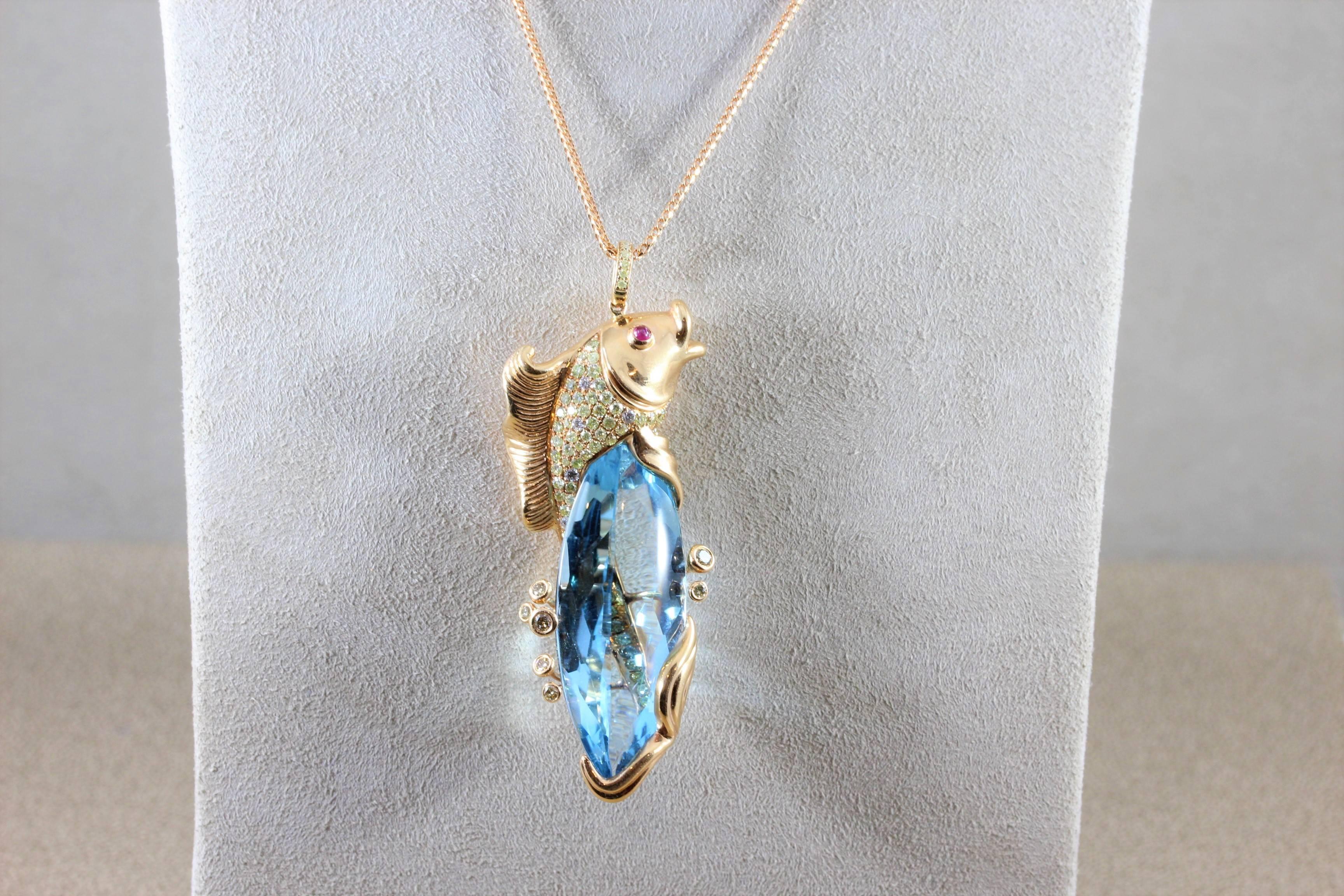 A uniquely beautiful rose gold pendant featuring a fine 41.90 carat blue topaz. The gemstone is surrounded by a diamond studded koi fish that wraps around the stone. The 18K rose gold koi fish has two ruby cabochon eyes.

Pendant Length: 2 inches 
