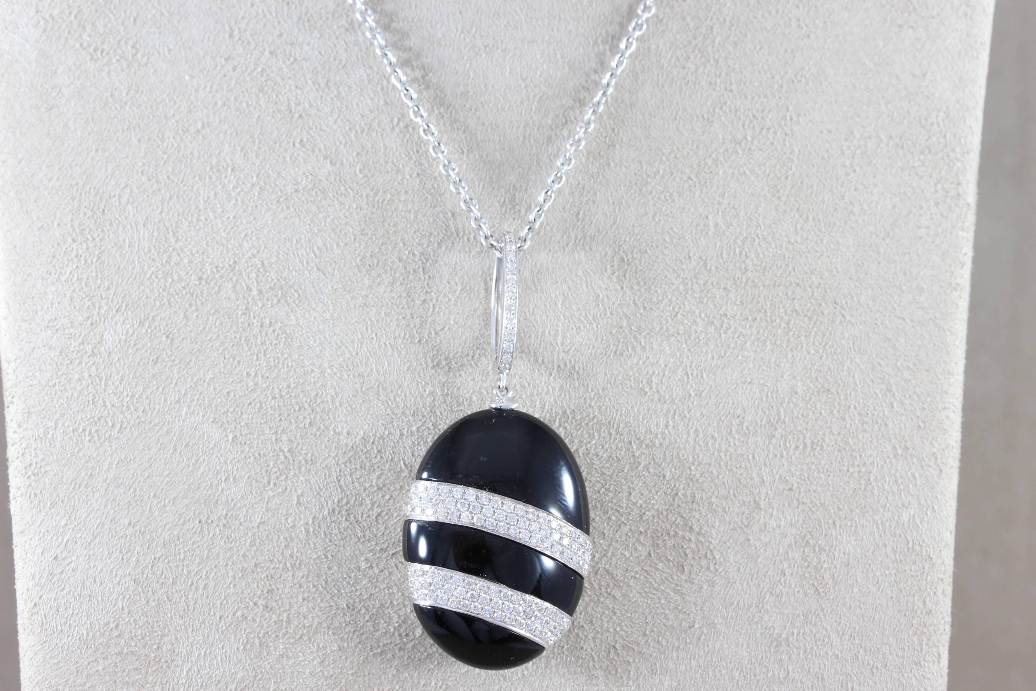A wonderfully unique pendant that is a 34.95 carat piece of fine black onyx which has been carved in with white gold adding contrast. The pendant features 1 carat of VS quality round cut diamonds, set in 18K white gold. 

Pendant Length: 1.10