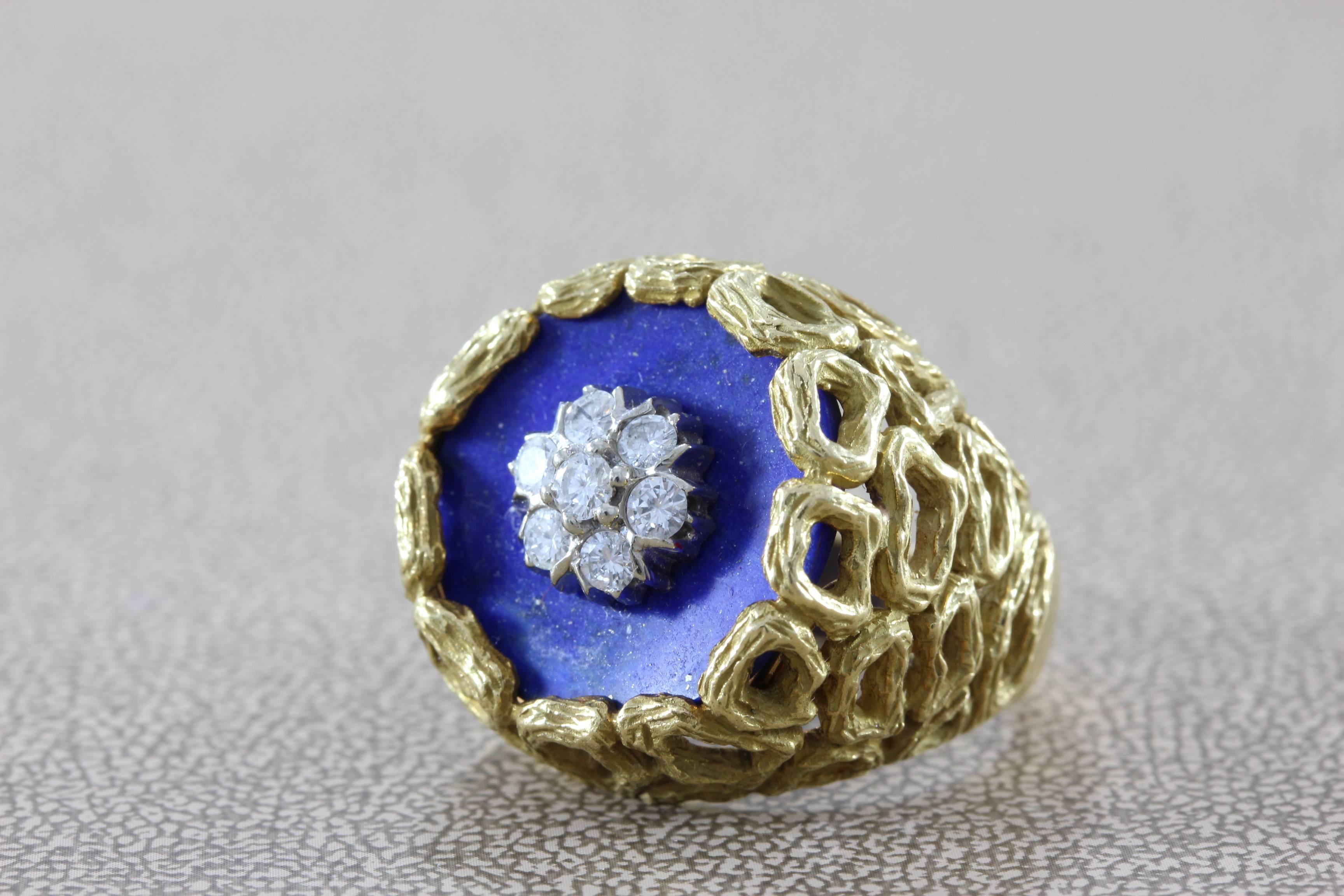 The detail work on this vintage ring is exceptional.  It features 0.40 carats of diamonds clustered on top of a vibrant blue lapis lazuli stone.  The 18K yellow gold ring shank is masterfully crafted with a hollow detail finish that you can only