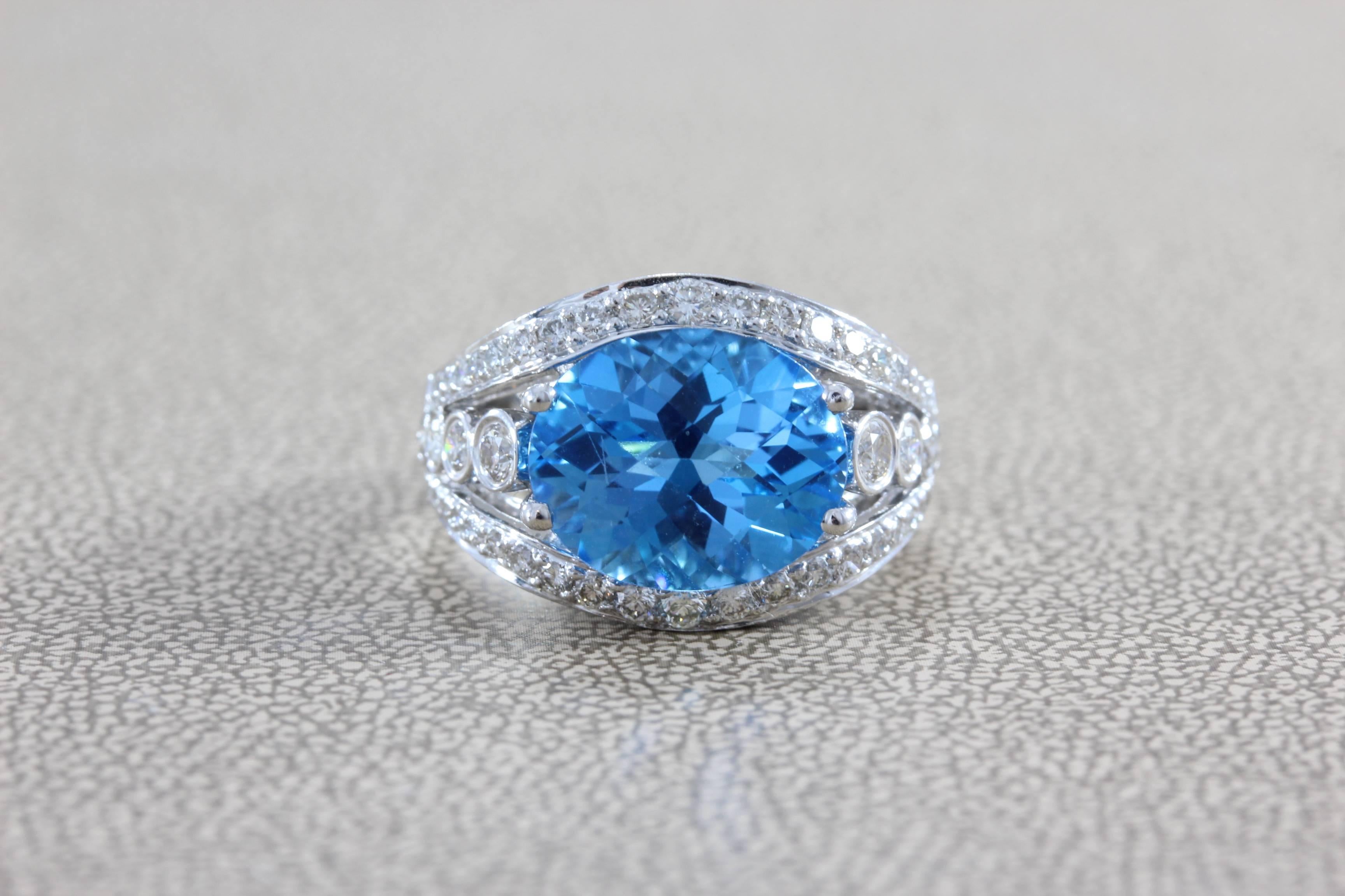 A majestic 5.85 carat ocean blue topaz is set in 18K white gold.  The oval cut topaz has a modern checkerboard cut top.  1.17 carats of VS clarity diamonds surround the majestic topaz in a special design.  

Ring size 6 ½

