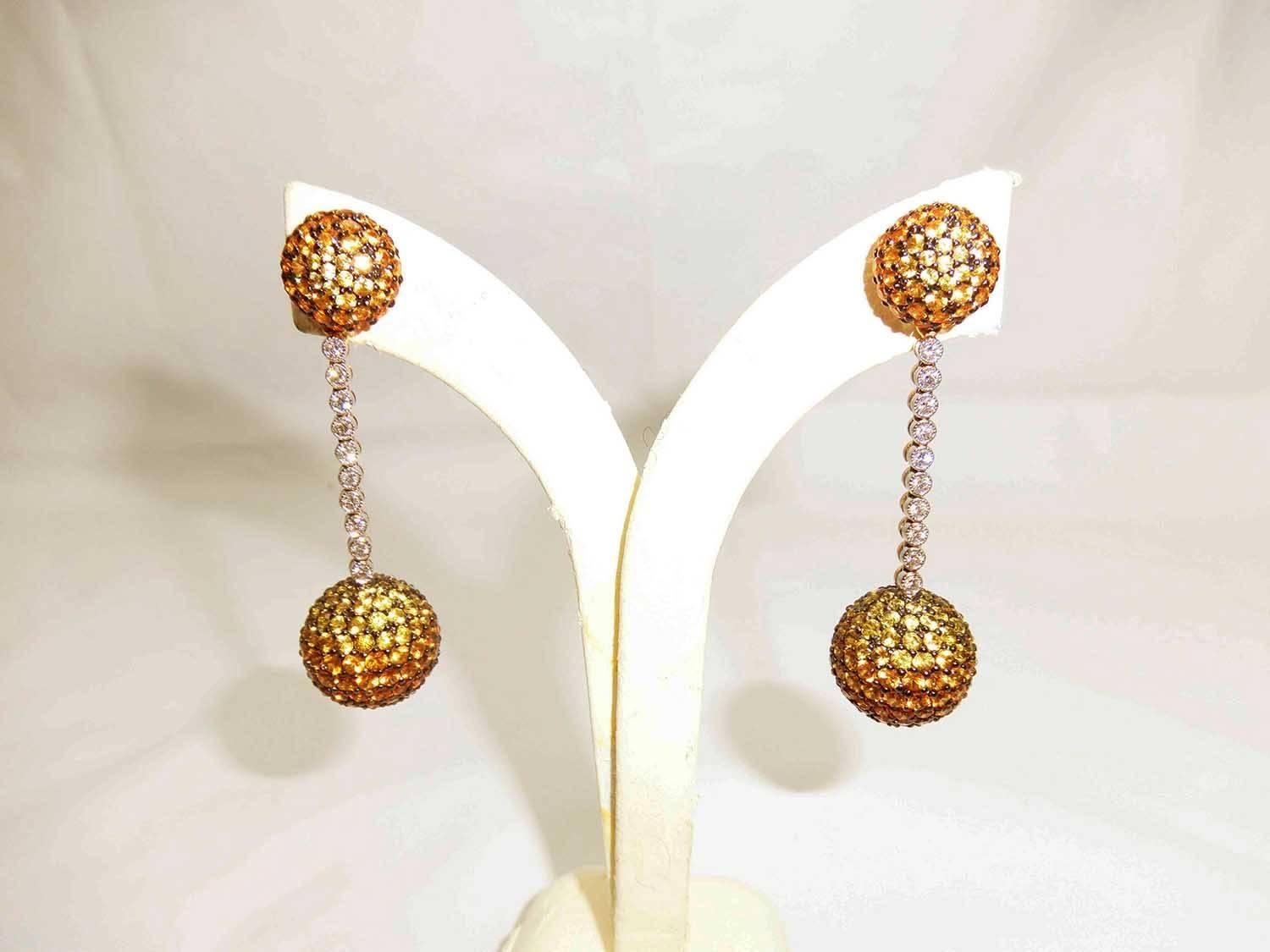 18 Karat White gold Yellow, Orange Sapphire Diamond Gold Two Balls Earrings 

2 Balls earrings made in 18k Gold.It make in modern style .We shaded color of yellow and orange sapphire to show the powerful of color.This earrings can detachable so you