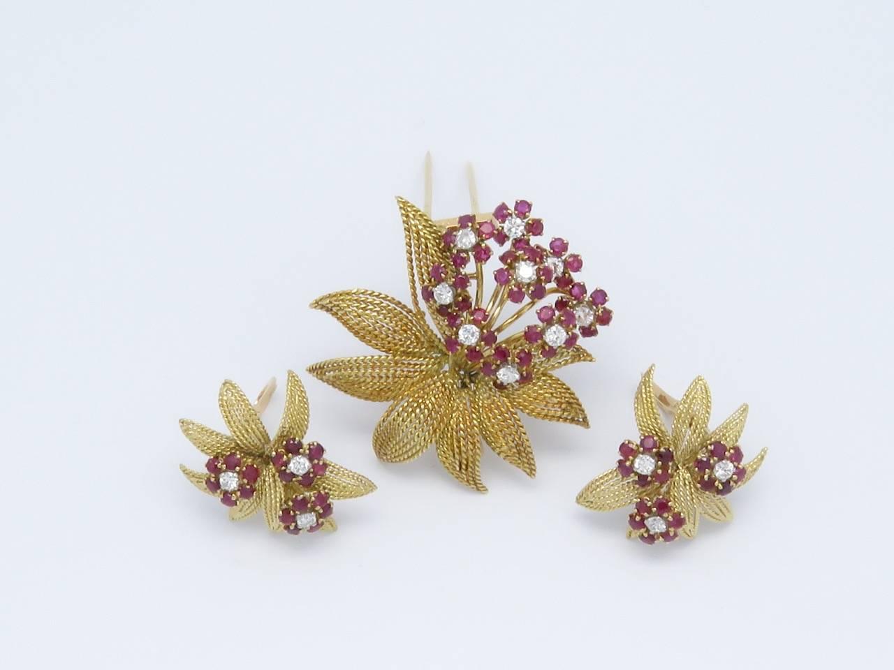 18K Gold,Diamonds and Ruby Earrings and Brooch Set. Signed by  J.LACLOCHE Paris-Cannes.
Circa 1950
Measurements:
Earrings:
 Length: 1.18 in (3cm)    Width: 1.18in (3cm)      Weight: 14.2 Grams
Brooch:
 Diameter: 1.85 in      Weight: 18.8