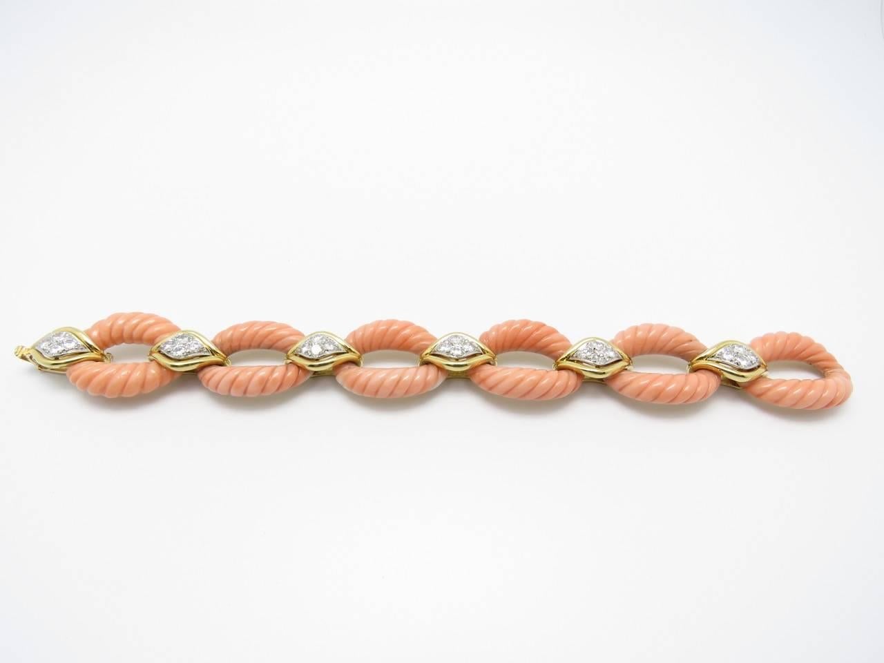 Charming coral and diamonds set on yellow gold are a delightful match of color and design for this  chain bracelet.  
French jewelry.
Marked: OJ Perrin Paris
Measurements:
Gold and Coral Link: 2,.8 x 2.2 cm
Gold and Diamond Link:1.8x1