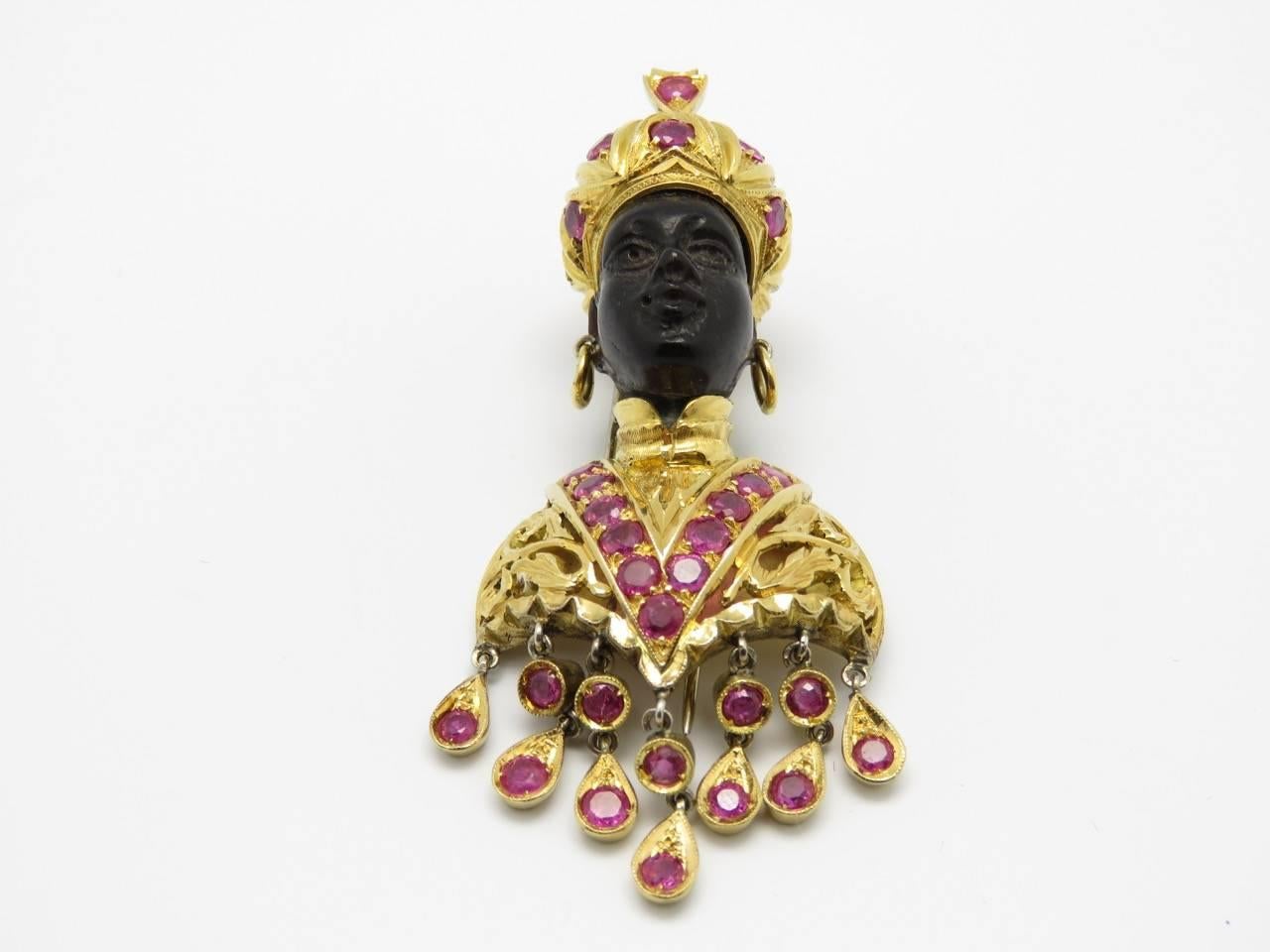 A Black Amber,Ruby and 18k Yellow Gold Clip by L.Nardi
Circa 1960

Dimensions:
2.36 in H x 1.02 W

Weight: 25.70 grams