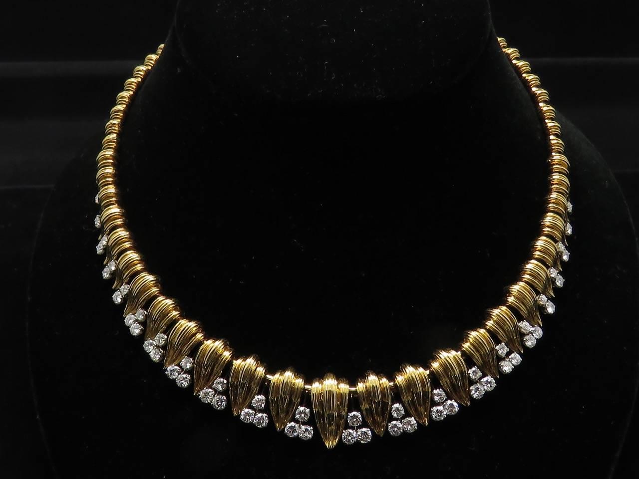 18 Karat yellow gold platinum custom made diamonds approximately 6 carats necklace.
Signed Mauboussin Paris and Numbered.
Weight: 87.4 grams
Length: 15.75 inches (  40 cm)  Maximun Width: 3/8 inch
Made in France.
Circa 1960.