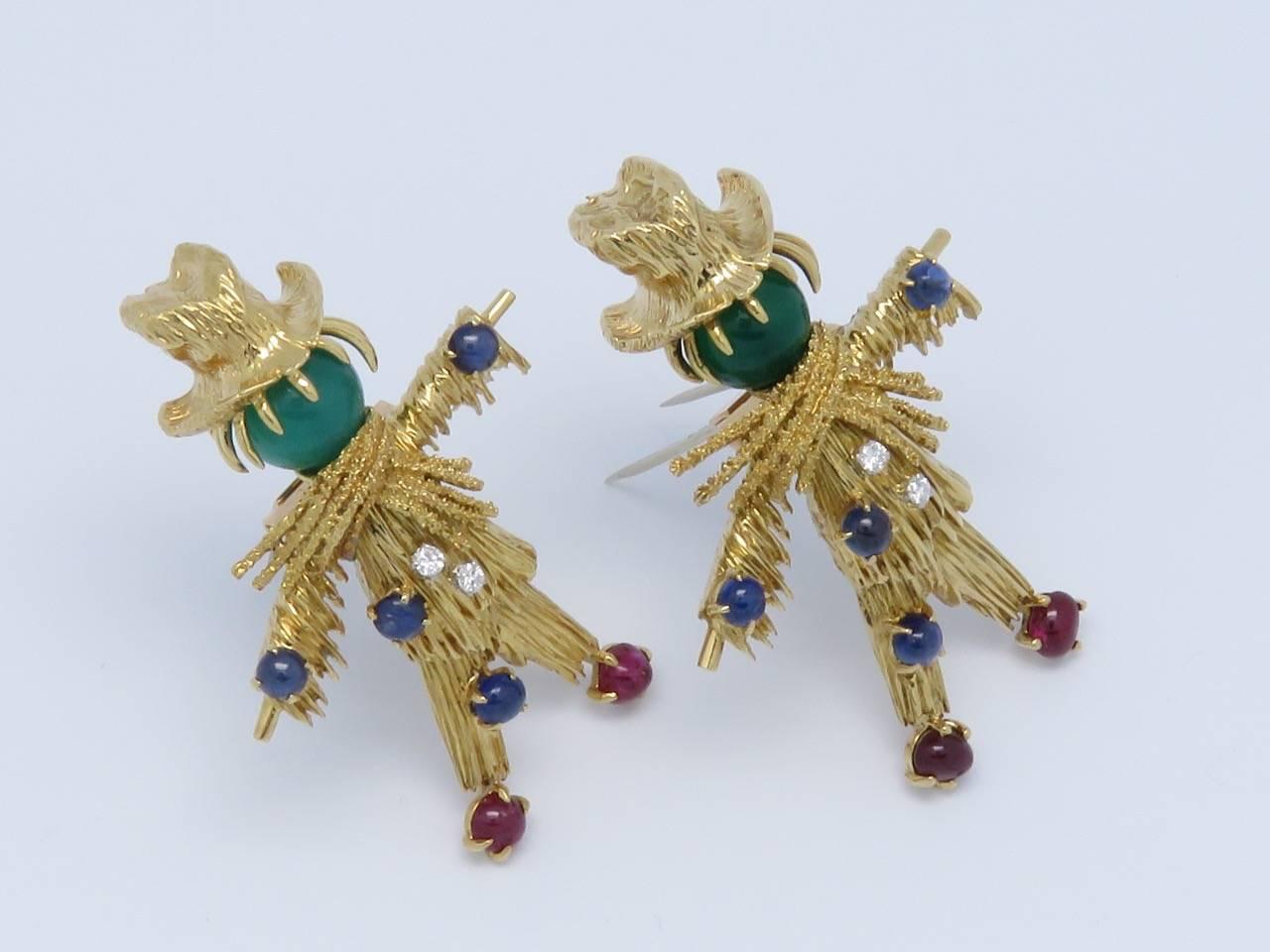 A Sapphire , Diamond , Ruby , Chrysoprase and 18K yellow gold clip.
Signed by Van Cleef and Arpels and Numbered.
Circa 1965.
Measurements:
The first brooch:
Length: 2.20 in (5.6cm)     Width: 1.5 in (3.8cm)         Weight: 23.4 Grams
The second