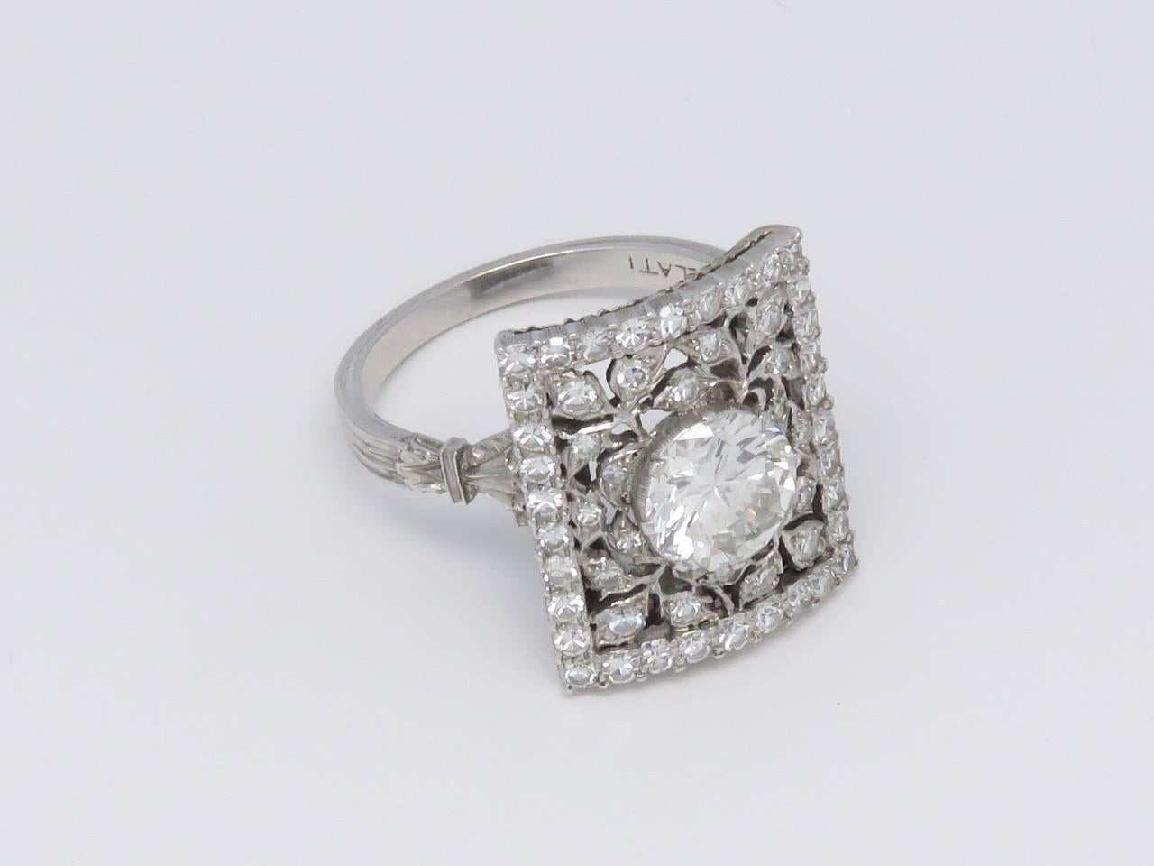 The main brilliant cut diamond weighing approximately 1.50 carat , within a circular cut diamond pierced openwork wide band to the textured white gold trim.
Signed by 