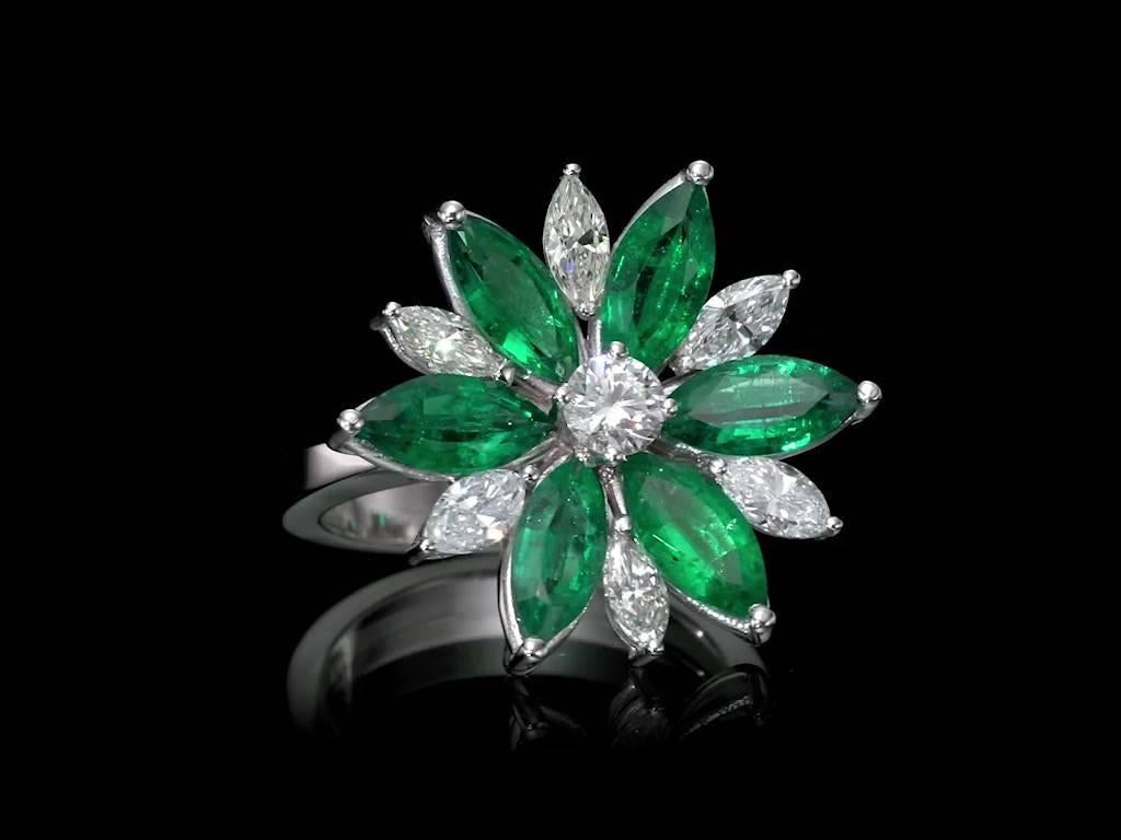 One of a kind Diamond and Emerald Floral ring set with 1.73 carat total Diamond weight and 3.8 Carat Emerald Total Weight. 
Ring is set with 6 marquise cut diamonds, 6 marquise cut emeralds and one round brilliant cut diamond. 
Our floral