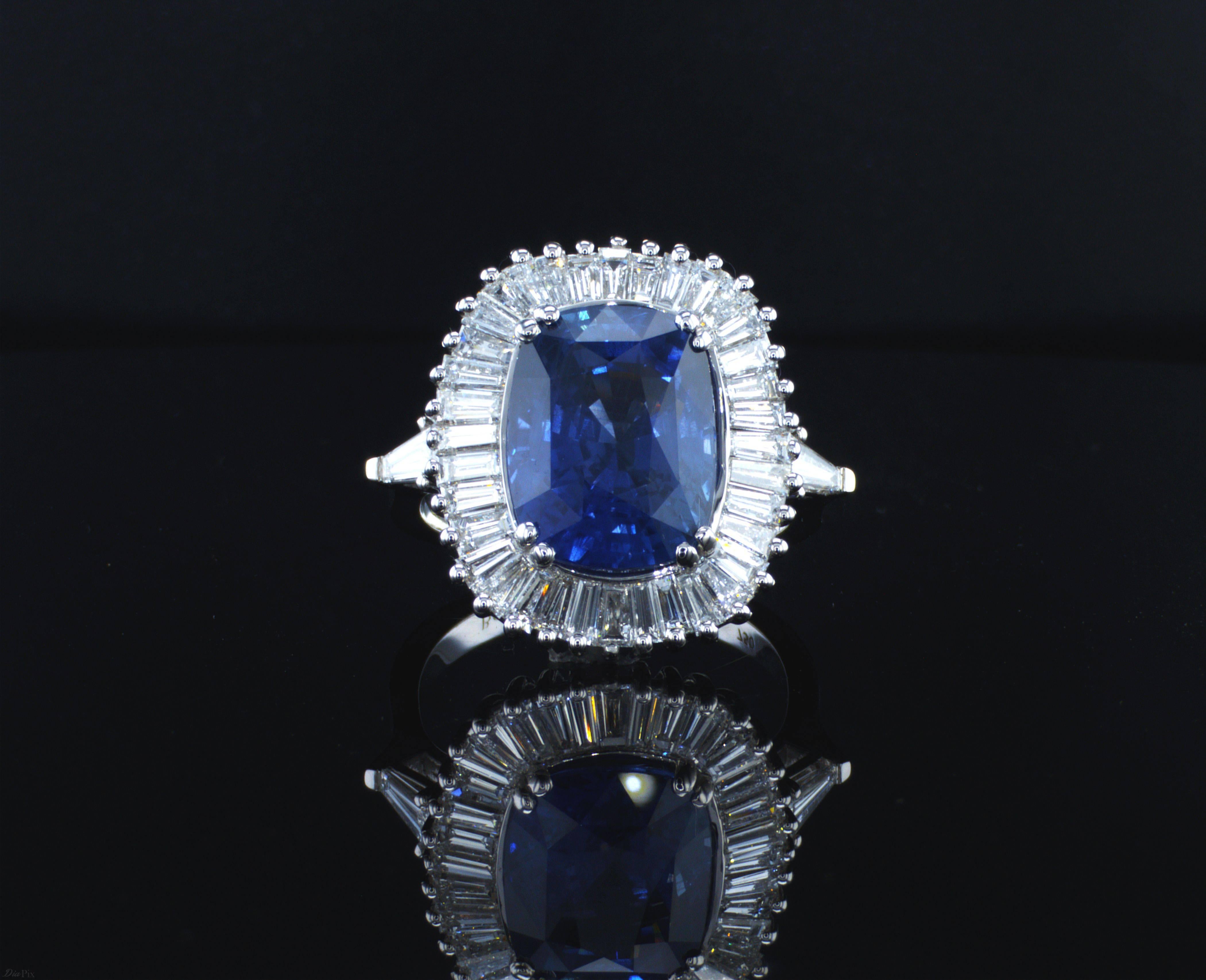 7.63 Carat Cushion Cut Blue Sapphire in border of 38 high quality tapered baguette shaped diamonds1.77 Carat TDW.  Our magnificent ring is made with precise detailed craftsmanship. 
Jewel Details: 

Center- 7.63 Carat Cushion Cut Natural Blue