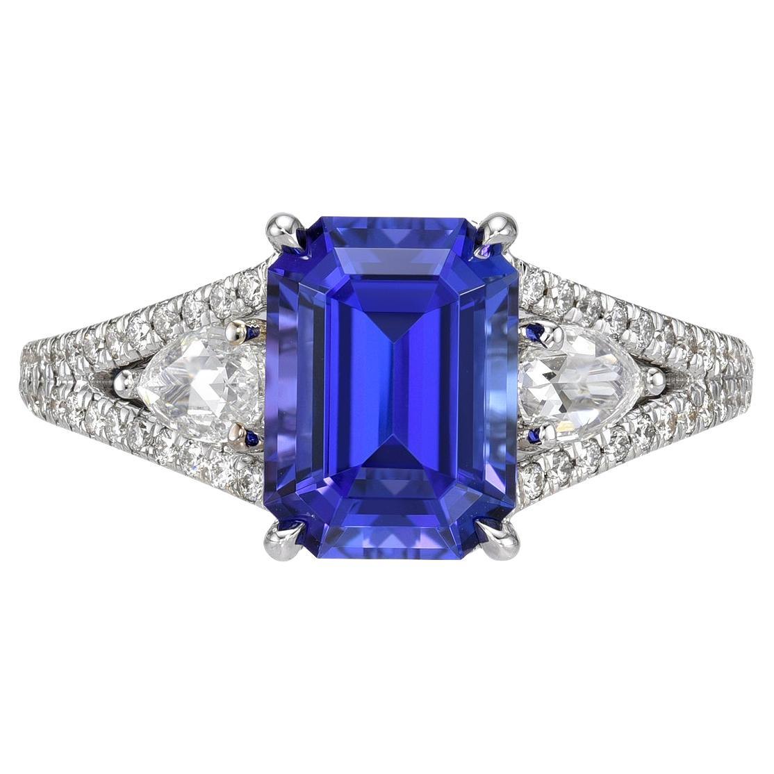 Captivating 2.56 carat Tanzanite Emerald Cut, 18K white gold ring, decorated with a total of 0.10 carat baguette diamonds, a pair of 0.27 carat Rose Cut pear shape diamonds, and a total of 0.23 carat round brilliant diamonds.
Ring size 6.5. Resizing