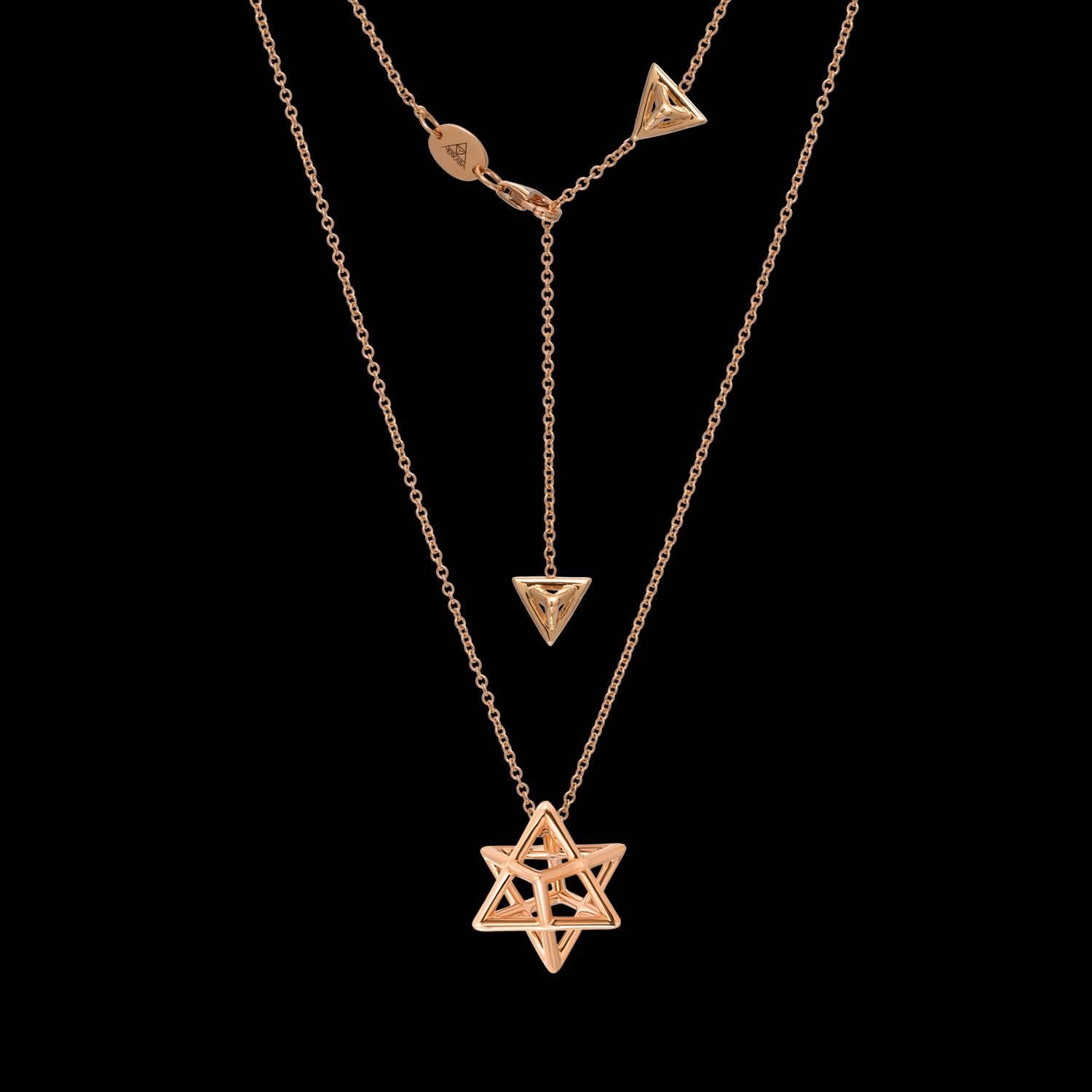 The Merkaba 18K rose gold necklace, is a heirloom-quality, sacred geometric jewelry piece highlighting superb attention to detail and extraordinary polish, symmetry and equilibrium. It suspends elegantly at the chest, measuring 0.68