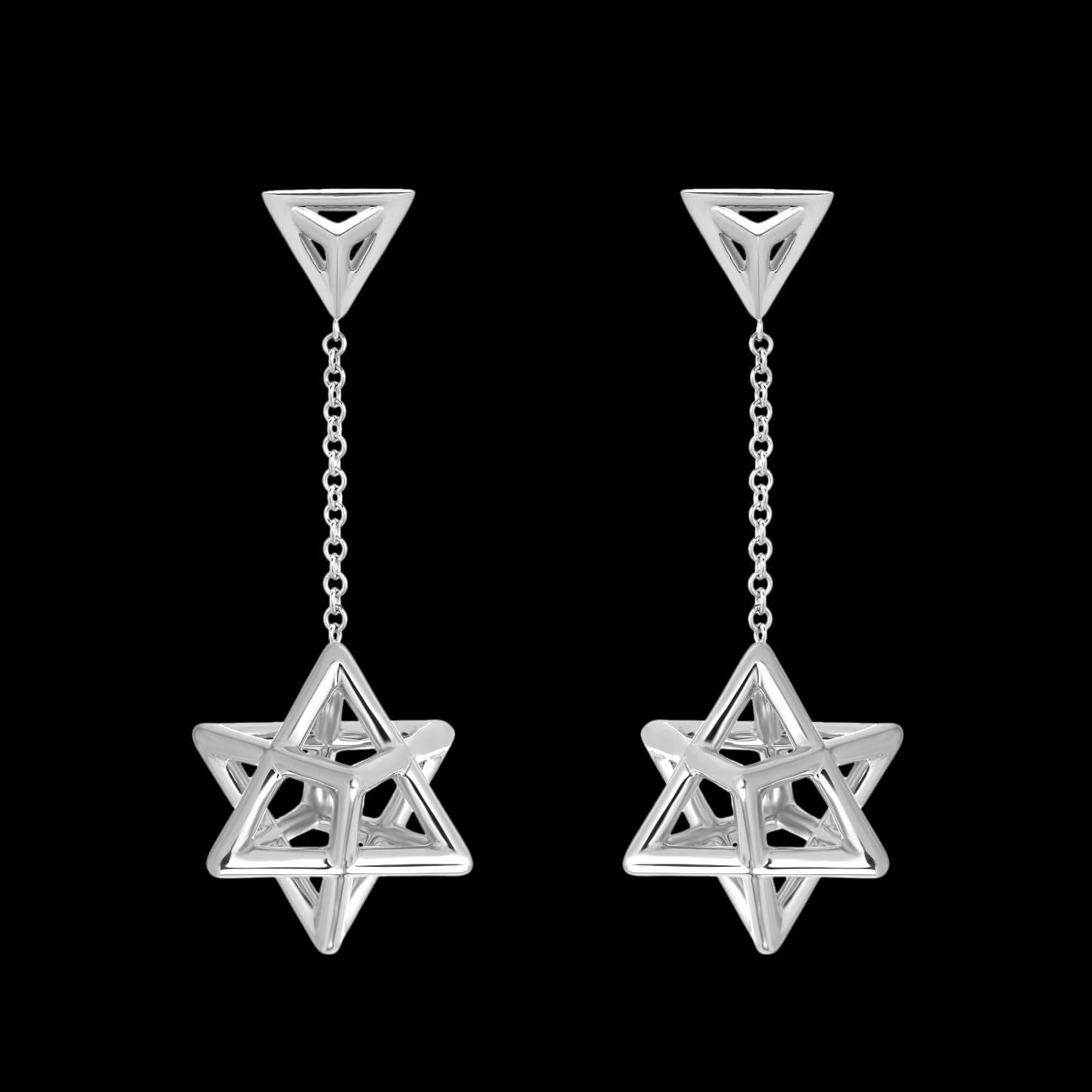 Merkaba platinum drop earrings, tethered by a triangle stud, feature a single chain suspending a three dimensional Merkaba star tetrahedron, measuring 0.57 inches. Secure La Pousette ear backs mirror the triangle motif. 
Total length - 1.5