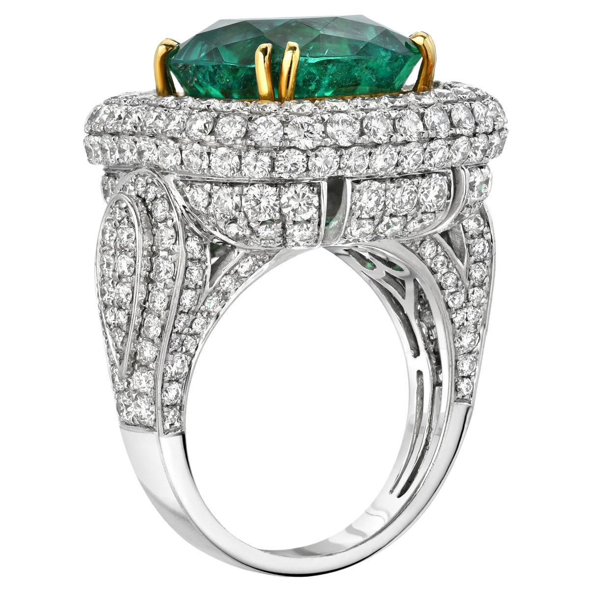Colombian Emerald ring showcasing an extremely vibrant 9.07 carat cushion cut Emerald, hand set in this spectacular 4.76 carat diamond, platinum and 18K yellow gold setting.
The Gubelin gem certificate is attached to the image selection for your