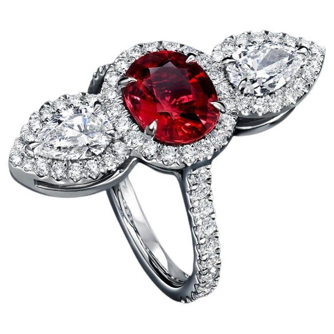 Superb natural Ruby ring featuring a 2.09 carat unheated Ruby oval, and a pair of GIA certified 1.01 carat pear shaped diamonds, D/VVS2-VS1, set vertically in this breathtaking platinum setting. The round brilliant diamonds framing the ring weigh a