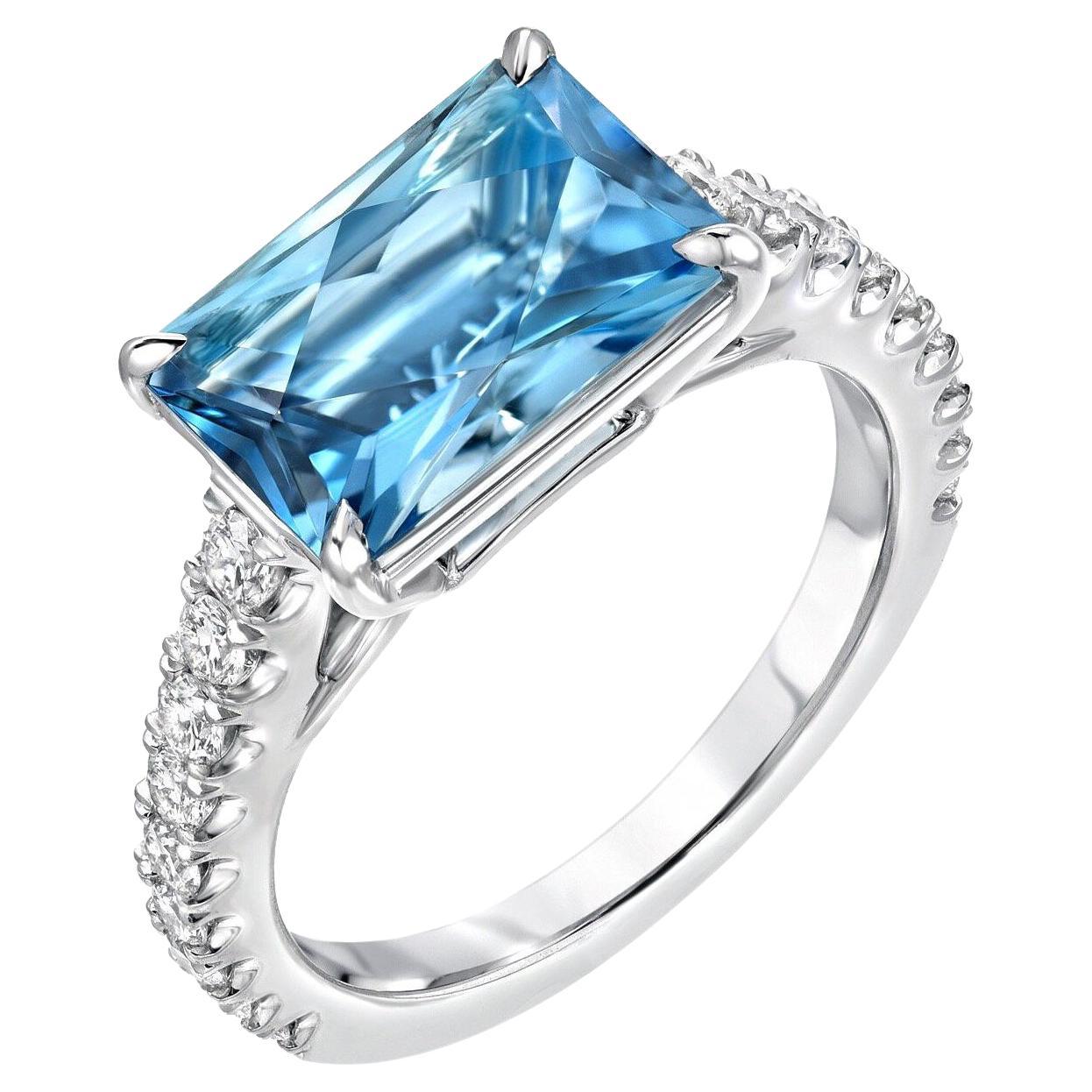 This unique, custom cut 2.59 carat Aquamarine, blends an emerald cut outline with a radiant cut, to maximize the brilliance of the gem. It is hand set horizontally in a striking 0.52 carat round brilliant diamond platinum cocktail ring, crafted