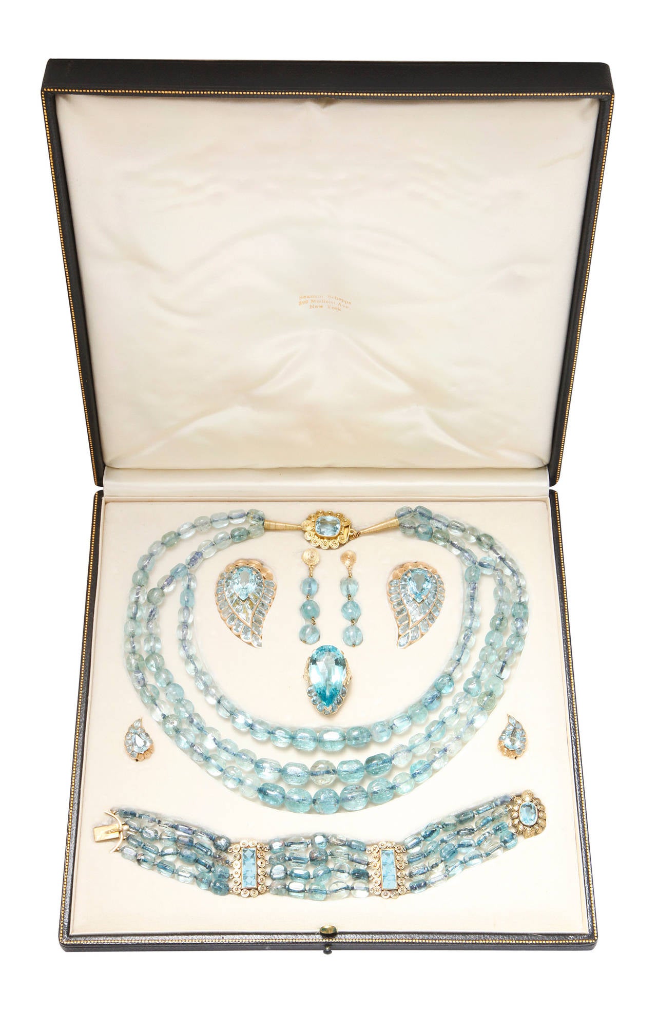 Aqua parure including a necklace, 2 pairs of earrings, a bracelet, a ring and a pair of clips by Seaman Schepps in original fitted box.