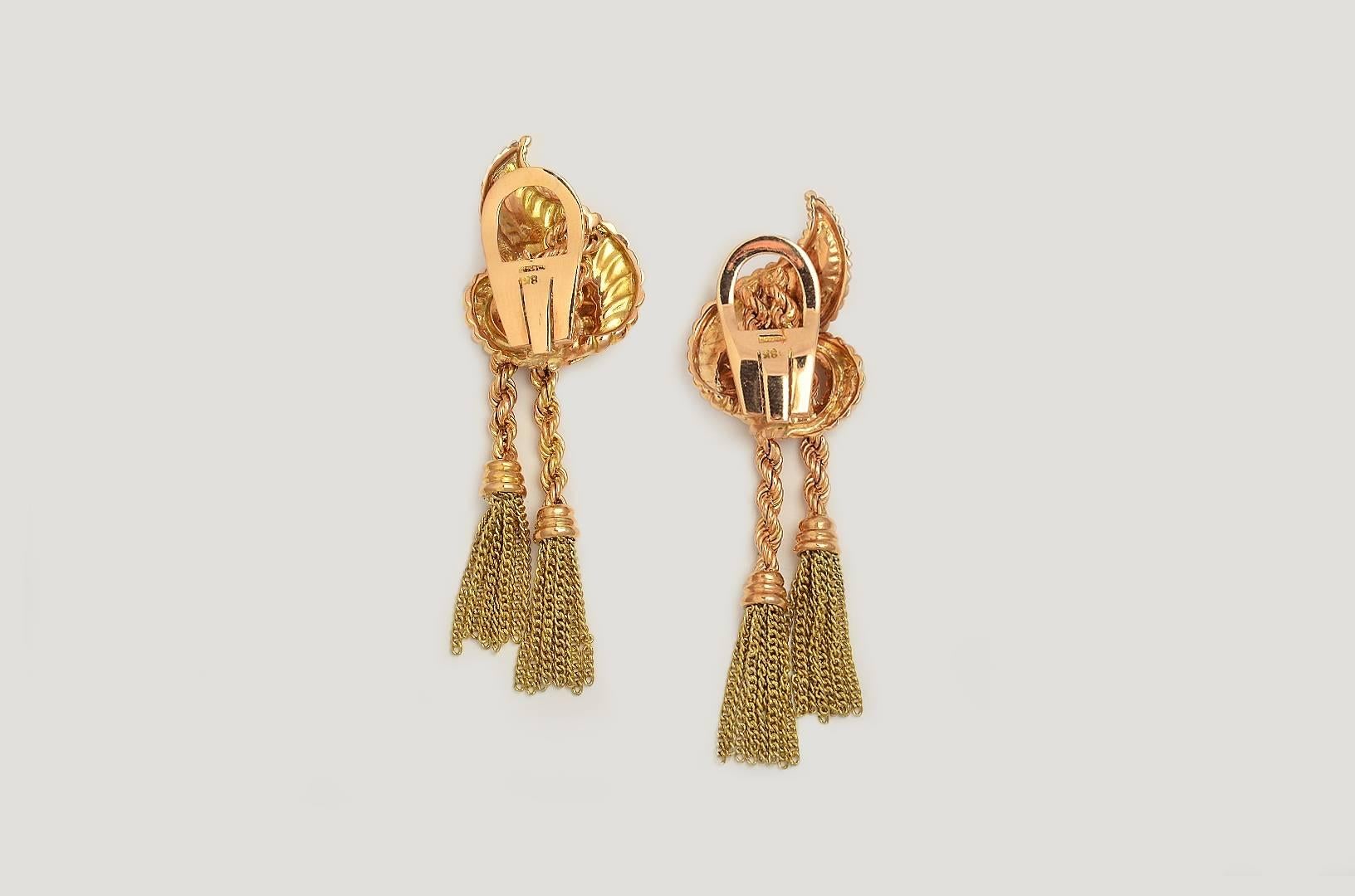 Made of Pink and Yellow Gold 18 Kts. and Platinum tassel earrings from the late 1940s. A pair of tassels falls assymetrically from each swirl motif ear clip set in pink-yellow Gold 18 kts, platinum and brillant cut-diamonds.