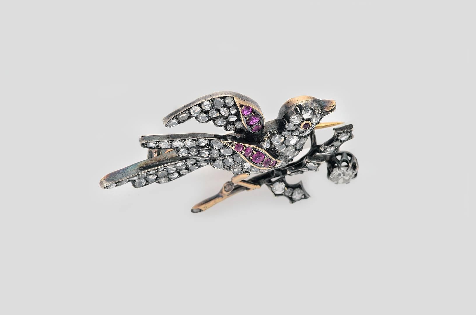 Made of Silver and 18 Kts. Gold in the form of a Bird Brooch with an Antique Fancy Yellow Diamond weighing 0´40 carats, surrounded by old european cut - diamonds and rose cut - diamonds weighing 1´20 carats. and rubies
French assay marks.