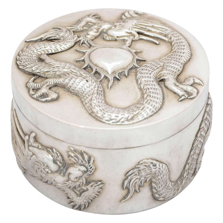 Chinese Export Silver Box with applied dragon decoration on a plain background. This box is a particularly fine example, and better quality than usual, weighing 226gms. The diameter is 8.2cm. It has a gilded interior.