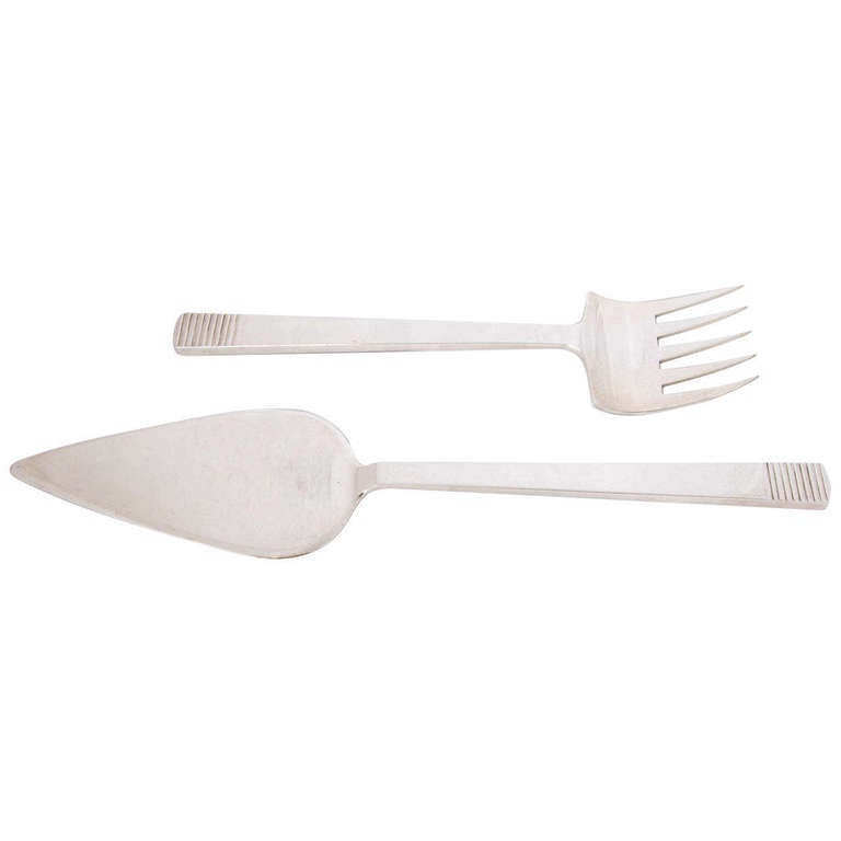 An unusual pair of sterling silver fish servers by the renowned English silversmith Charles Boyton. In the 1930's his designs were among the best art deco silver being produced anywhere and his pieces, including this pair of servers, were often