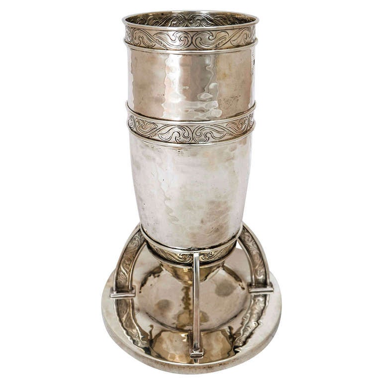 An English Sterling Silver Vase of Arts & Crafts design, made by William Hutton & Sons in London 1905.
The vase is 22cms high; the diameter of the opening is 9.2cms;and the base is 13.5cms. The weight is 632gms.