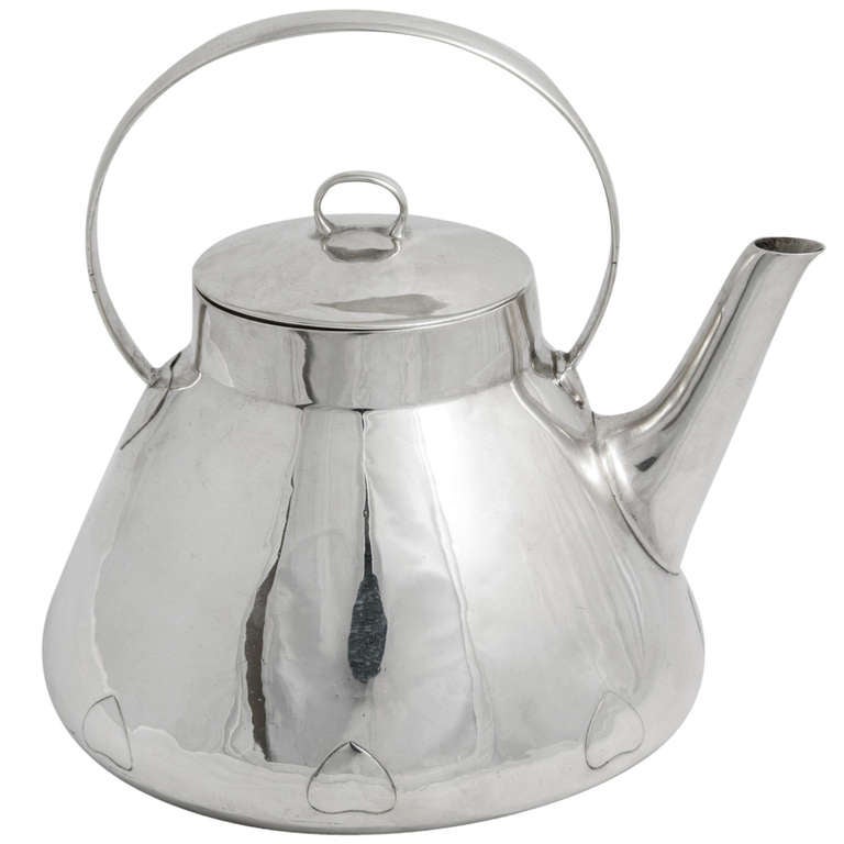 A Sterling silver teapot made by Liberty & Co. and hallmarked Birmingham 1909. Various eminent designers worked for Liberty's in the art nouveau period and this is likely to have been the work of the most famous of them all, Archibald Knox.